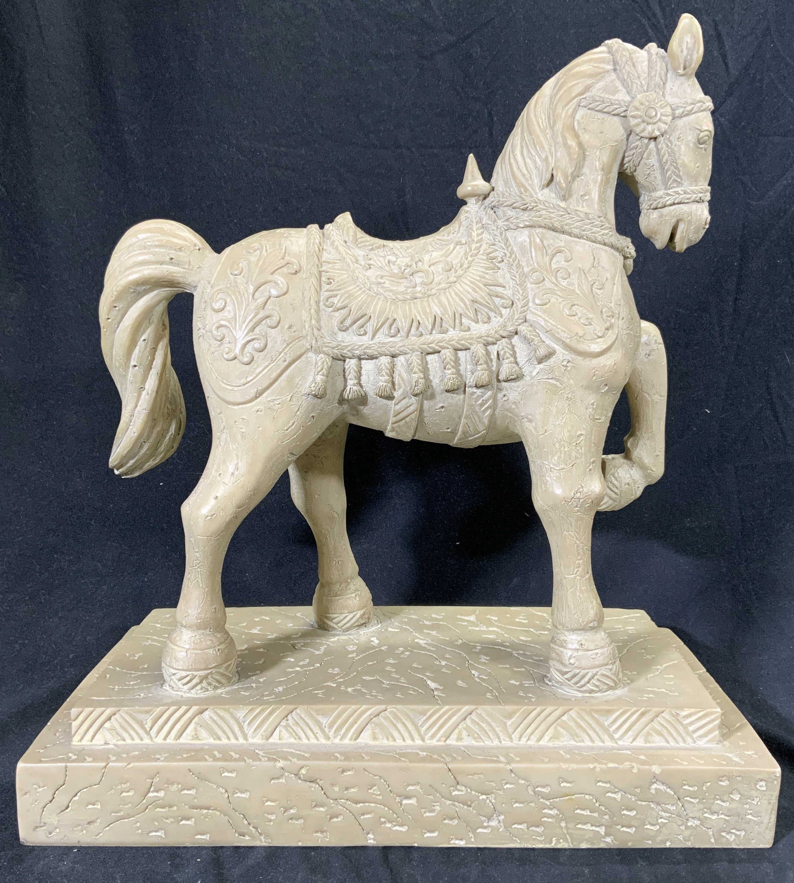 Vintage Resinous Horse Sculpture Figural: Horse sculpture is sand toned. Sculpture is a resinous material. Piece has intricate relief detail with facial, saddle, scroll & tassels. Horse sculpture has 1 hoof raised. Horse is depicted standing 