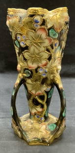Vintage Gilt Porcelain Floral Vase: Vintage hand painted gilt porcelain vase with raised floral motif. Hues of black, green, and pink. Measures approx. 4 x 9 inches. Some surface wear including scratching observed. Vase, porcelain