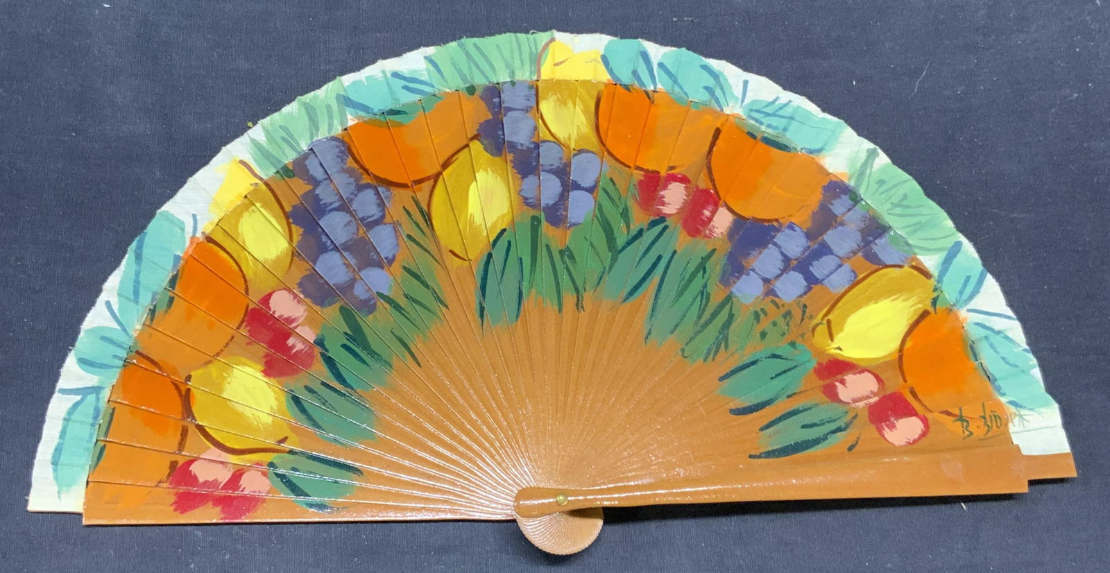 Vintage Signed Hand Painted Fruit Motif Fan: Vintage signed hand painted fan with fruit motif. Wood and fabric. Signed illegibly on lower right. Measures approx. 16 inches wide. Some wear to materials and loss to paint observed. Fan, vintage fan