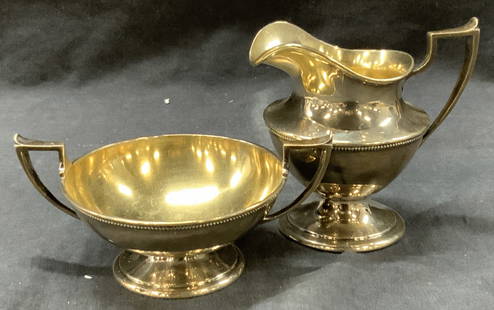 2 Sterling Silver Stamped Kitchen Accessories: 2 sterling silver stamped kitchen accessories. 1 creamer pitcher with side handles and lipped rim. And double handled footed sugar bowl. Approx 1.5 and 2.5 inches tall and 4 and 5 inches wide.