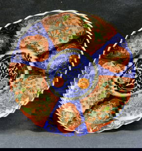Vintage Asian Imari Porcelain Platter: Vintage Asian imari porcelain platter. Gilt with hand painted floral motif in blue and red. Scalloped rim. Low profile foot. Measures approx. 12 inches wide. Some surface wear including