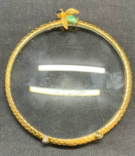 Vintage Gold Tn Crystal Insect Magnifying Glass: Vintage gold tone insect motif magnifying glass with crystal decoration. Raised dot pattern on frame. Measures approx. 2.75 inches wide. Includes suede pouch. Some surface wear including
