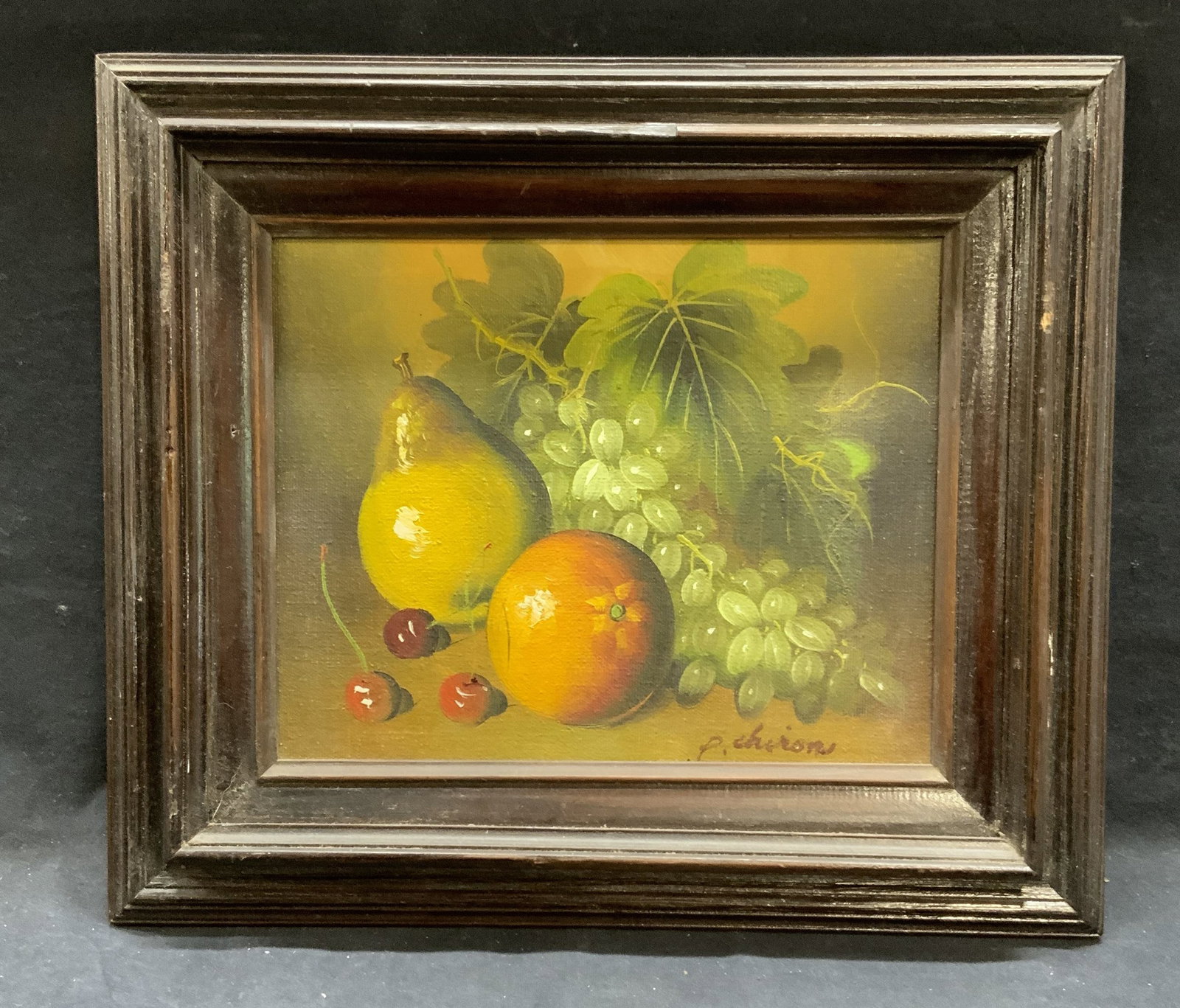 Signed P Chiron Still Life Oil Painting: Signed P. Chiron still life oil painting. Signed to lower right. Subject depicts pear, orange, cherries, and grapes in green, orange and red. Framed in dark wood frame. Measures approx. 12.75 x 14.5 i