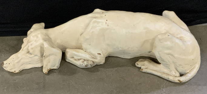 Vintage Floor Sized Sleeping Dog Sculpture 26in: A vintage sleeping dog sculpture. Floor sized. Painted a cream hue. Grey hued paint to the eyes. Appears to be crafted from composite or foam material and has a heavy painted finish. Piece has
