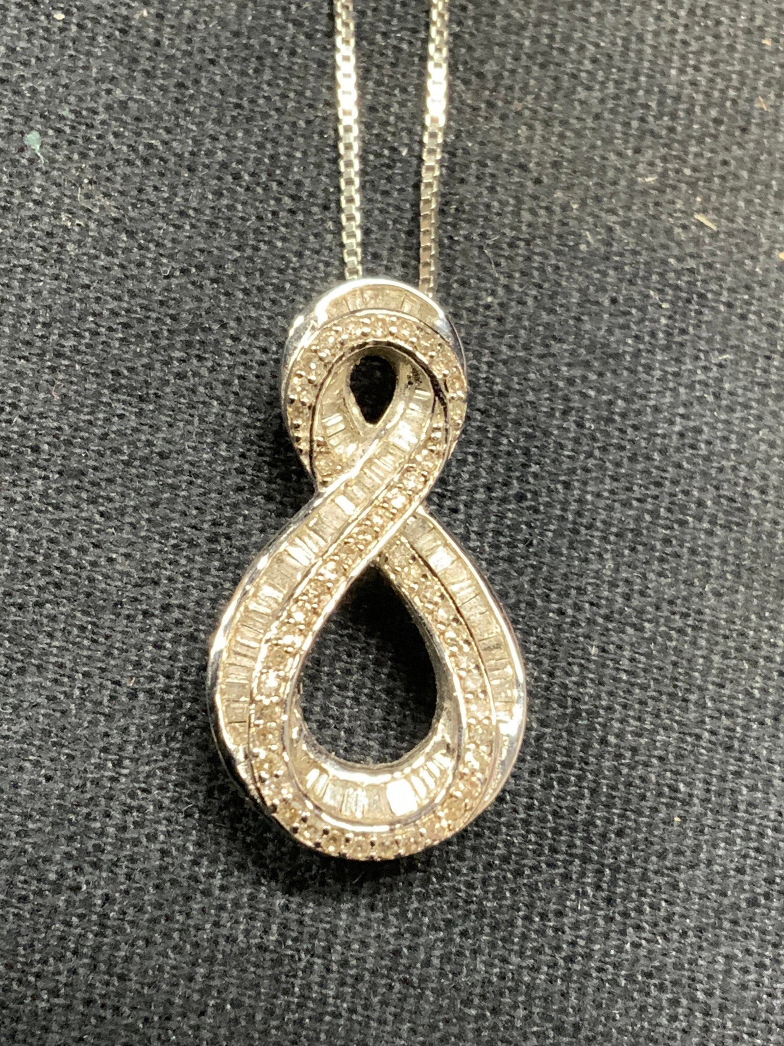 MP Sterling Silver Crystal Pendant Necklace: MP sterling silver pendant necklace with colorless crystal decorated pendant. Signed on pendant. Marked sterling on pendant. Marked illegibly on clasp. Drop length approx. 8.5 inches. Pendant measures