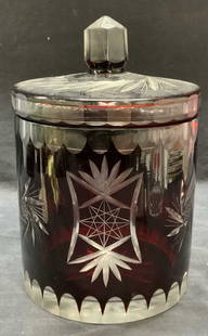 Vintage Cranberry to Clear Cut Crystal Vessel: Vintage cranberry to clear cut crystal vessel with lid. Geometric motif. Measures approx. 6.25 x 6.5 inches excluding lid. Thick walled crystal, piece has weight. Some surface wear including