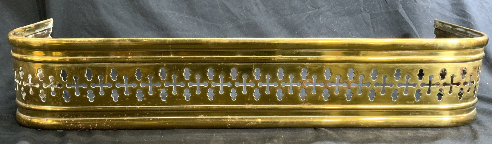 Vintage Brass Fireplace Fender W Pierced Detail: Fireplace fender is gold toned and brass. Piece appears to be vintage. Fender has pierced detail. Front of piece has rounded corners. Fireplace fender measures approximately 25 inches long 8 inches de