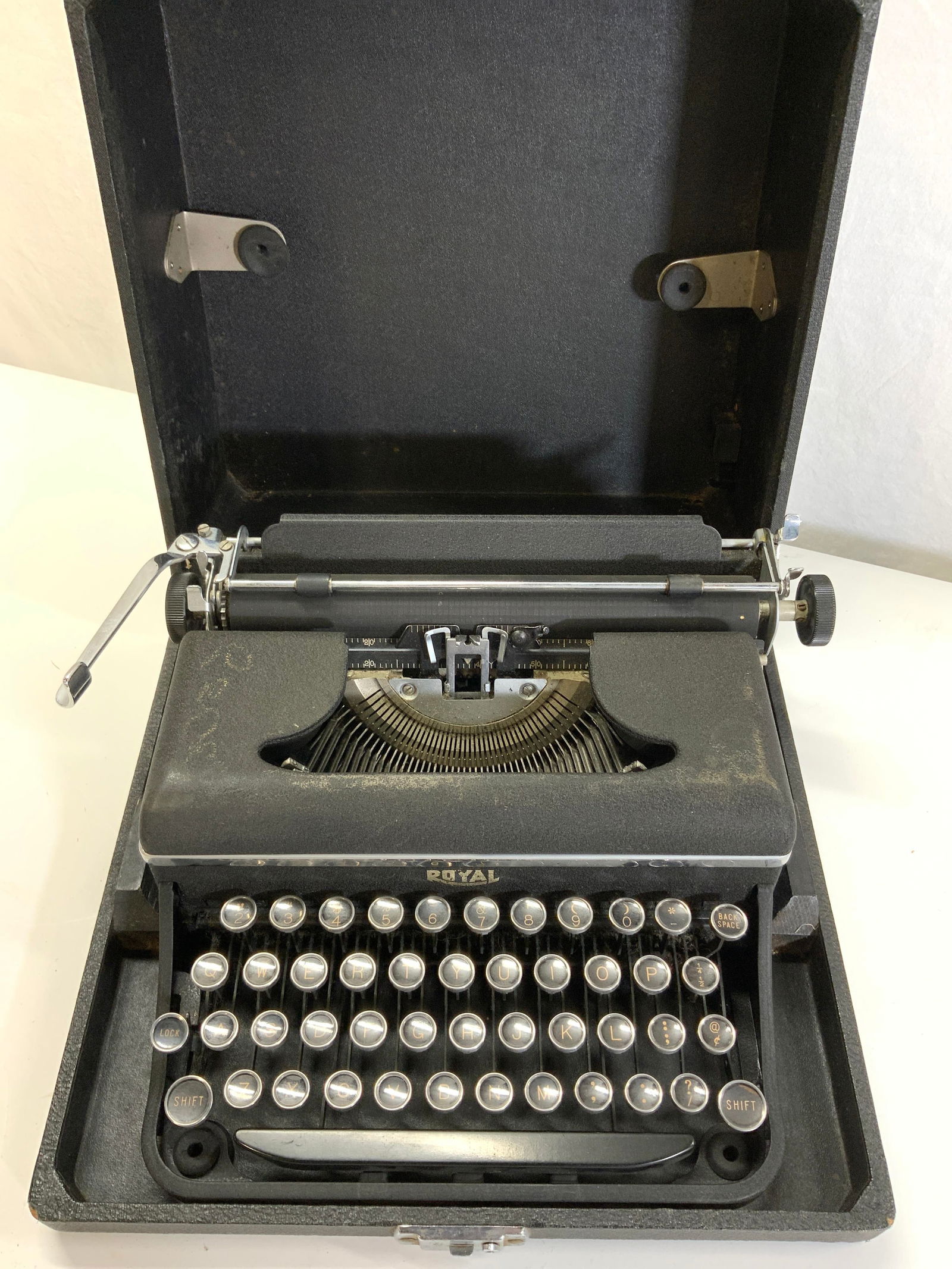 Vintage Royal Manual Typewriter In Case, 1940s: Heavy die cast black metal ROYAL manual typewriter , series/ model number UB-97067 ( located on back on typewriter. Comes in the original carry case. Portable typewriter. c. 1930s- 1940s. Measures 13
