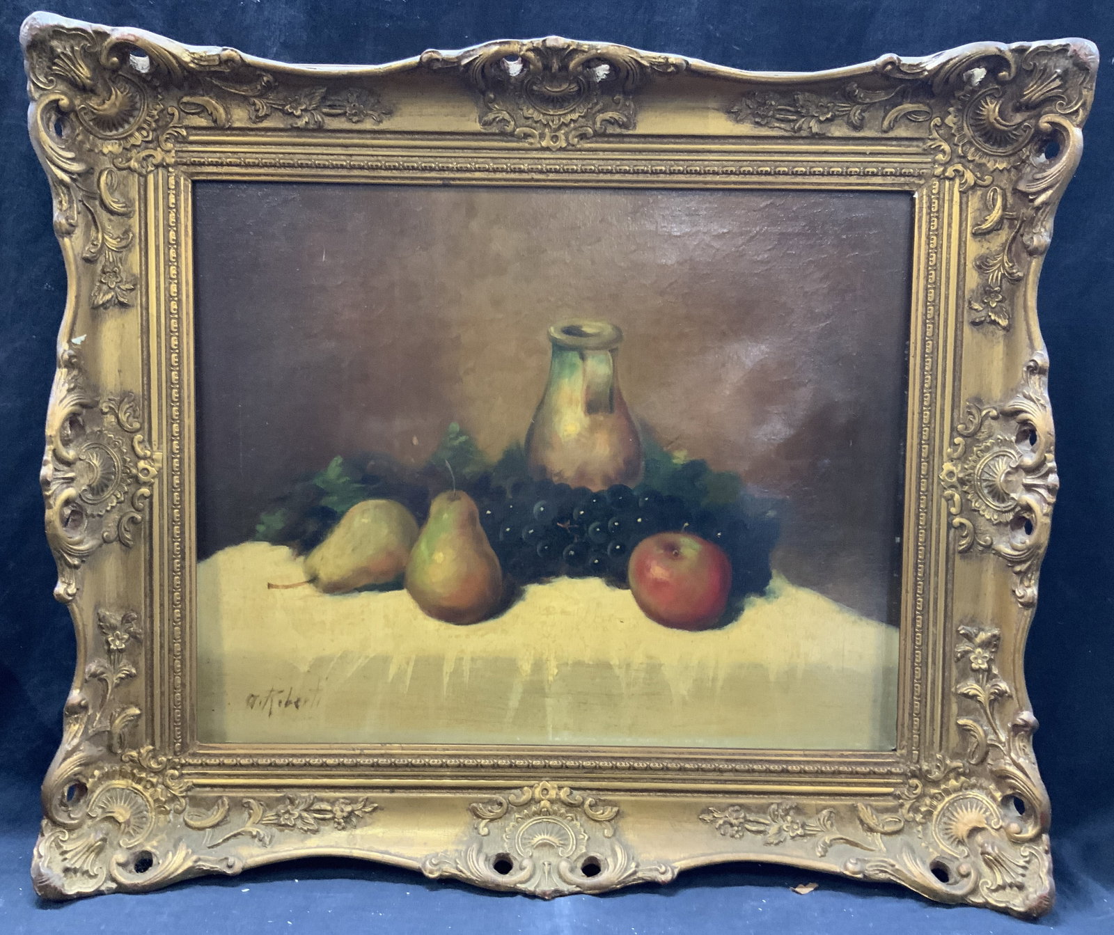 A Roberti Sgd Antique Still Life Oil Painting: Signed on corner A.Roberti Depicts a still life of fruits and a jug on a table. Framed in an ornately crafted wooden frame with gold leaf and roasted French style scroll and floral motifs on edges and