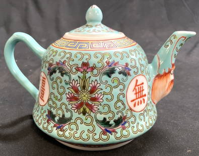 Vntg Hand Painted Asian Porcelain Teapot w Lid: Teapot is vintage and porcelain. Piece has intricate multi toned floral, leaf & Asian character detail, face detail at base of spout. Teapot has lid. Some elements appear to be hand painted.