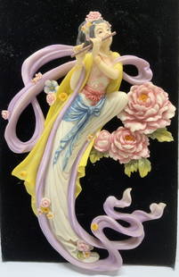 Chinese Dunhuang Goddess Wall Decor, Signed: Chinese feitian goddess playing the flute, floating amongst Famille roses. Based in Chinese Mythology. Signed reproduction piece. C 2001. Polyestone / resin wall hanging in colors of pink,
