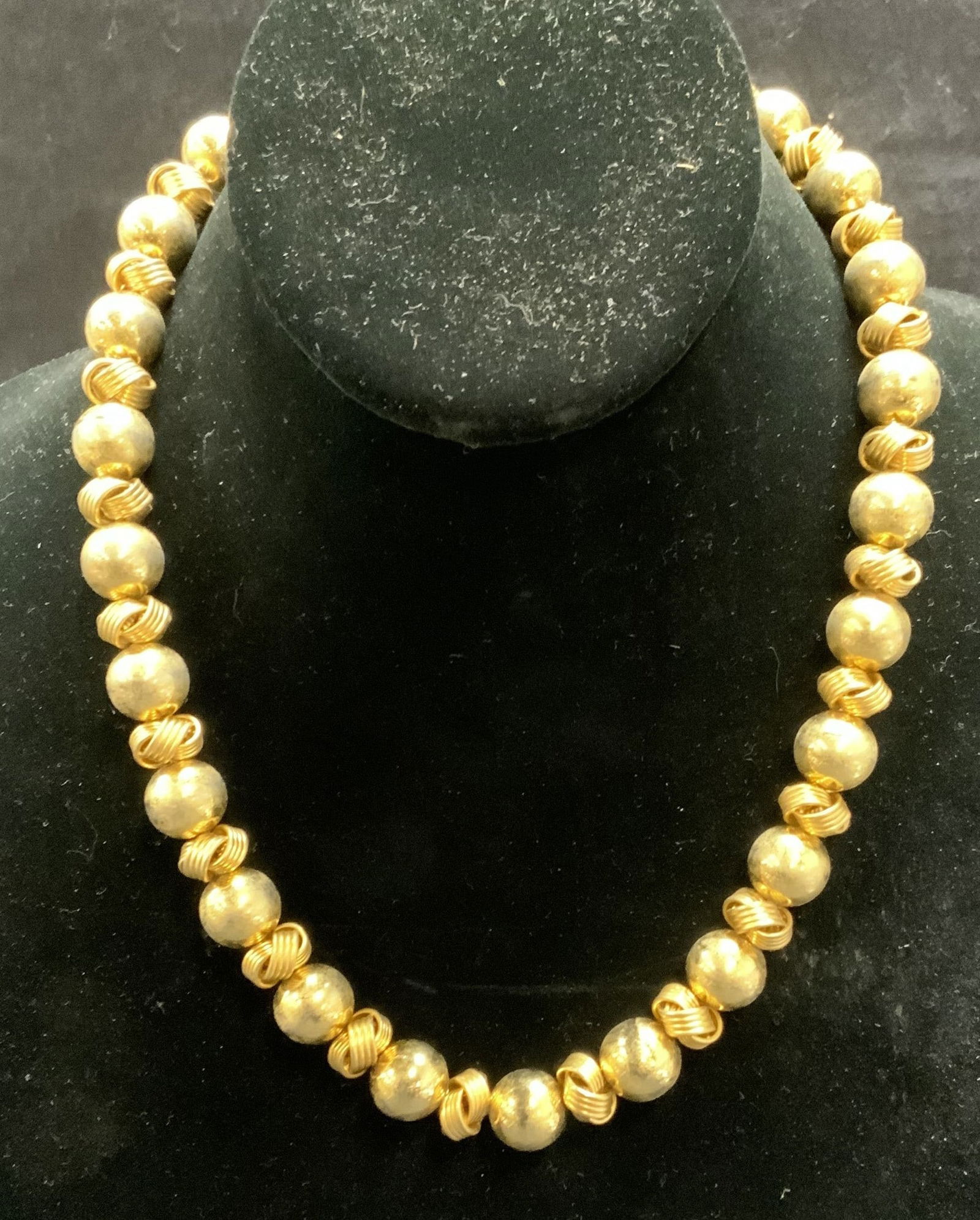 Anne Klein Gold Tone Knot Necklace: Anne Klein gold tone necklace with round and knot motif beads. Signed on hang tag. Drop length approx. 8.5 inches. Some surface wear including scratching observed. Estate jewelry, costume jewelry, coc