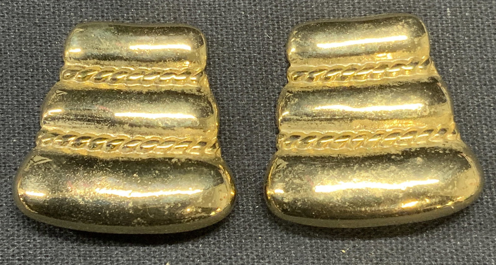 Vintage Bluette Gold Tone Sweater Clips, France: Pair of vintage Bluette gold tone sweater/shoe clips. Embossed raised dot and strip motif. Signed to underside. Made in France. Measure approx. 1 x 1 inches. Some surface wear including scratching obs
