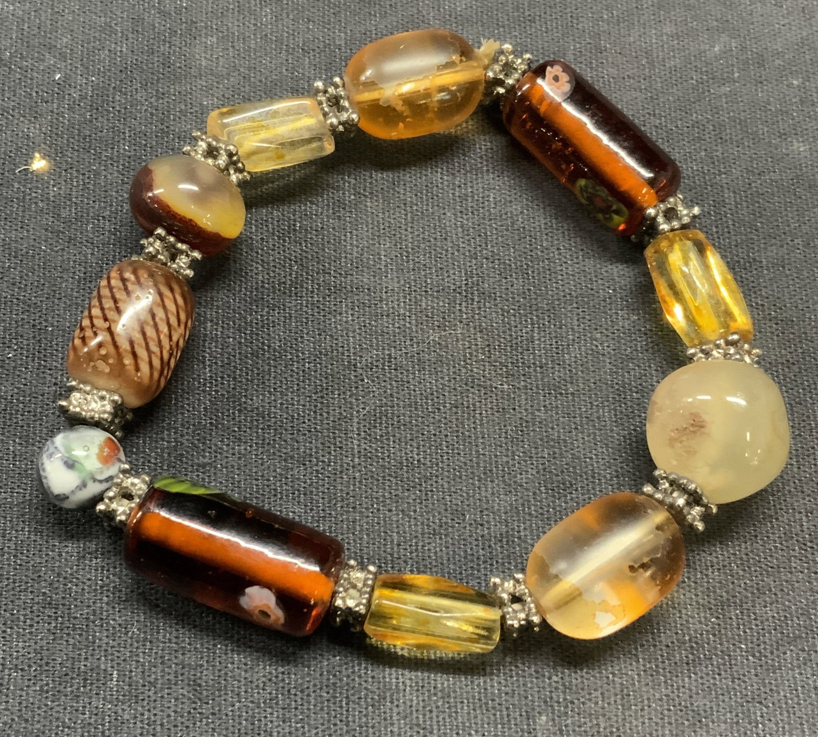 Vintage Art Glass Millefiori Bracelet: Vintage art glass beaded stretch bracelet with millefiori detail. Measures approx. 2.5 inches wide. Some surface wear including scratching observed. Estate jewelry, costume jewelry, cocktail jewelry, 