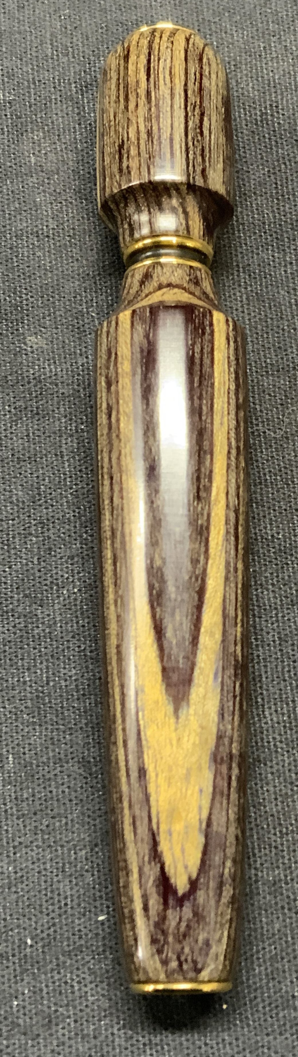 Gold Tone Wood Snuff Bottle: Wood snuff bottle with gold tone detail. Measures approx. 4 x 5/8 inches. Some surface wear including scratching observed. Snuff bottle, gold tone snuff bottle, wood snuff bottle, collectibles, home a