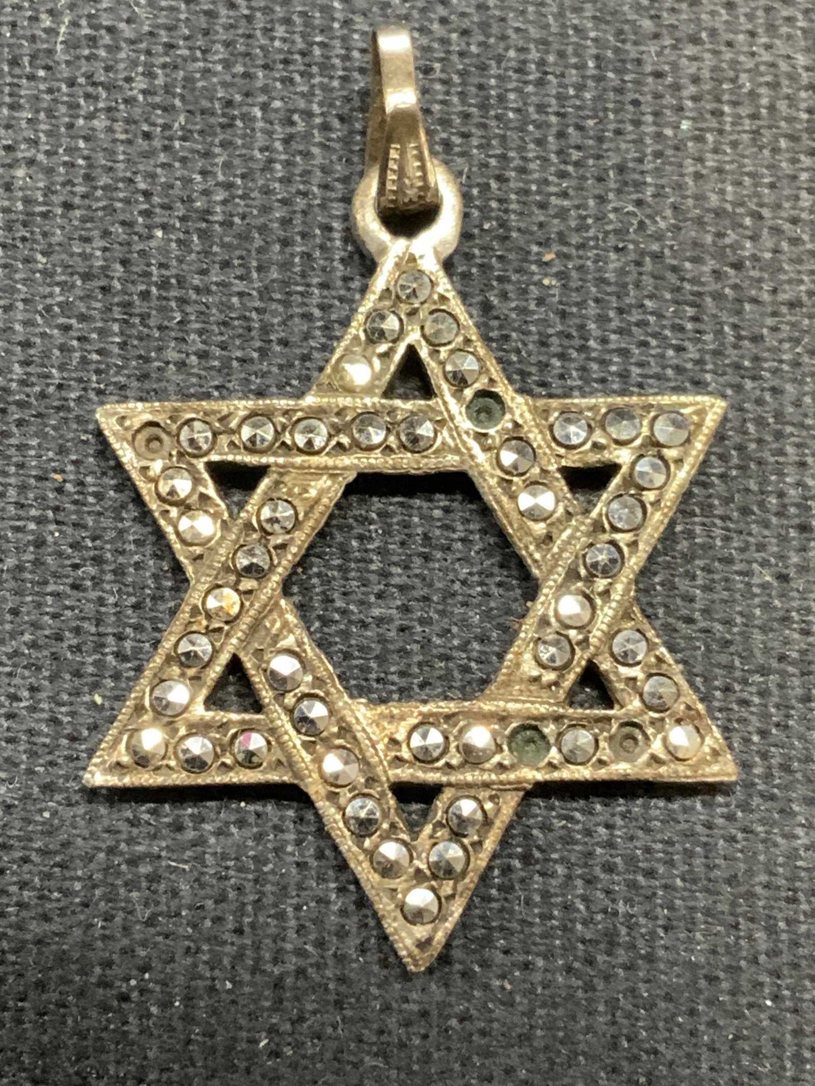 Sterling Silver Marcasite Star of David Pendant: Vintage sterling silver Star of David pendant with Marcasite decoration. Marked sterling. Measures approx. 1 x .75 inches. Total weight 2.4 grams. Some marcasite needs replacement. Some surface wear i
