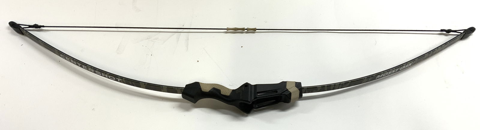 Barnett Centershot Compound Youth Bow Mossy Oak: Bow reads CENTERSHOT MOSSY OAK in white toned lettering. Handle reads BARNETT. Bow has camouflage detail. Bow measures approximately 44.5 inches tall 9 inches deep. CENTERSHOT Mossy Oak, CENTERSHOT Mo