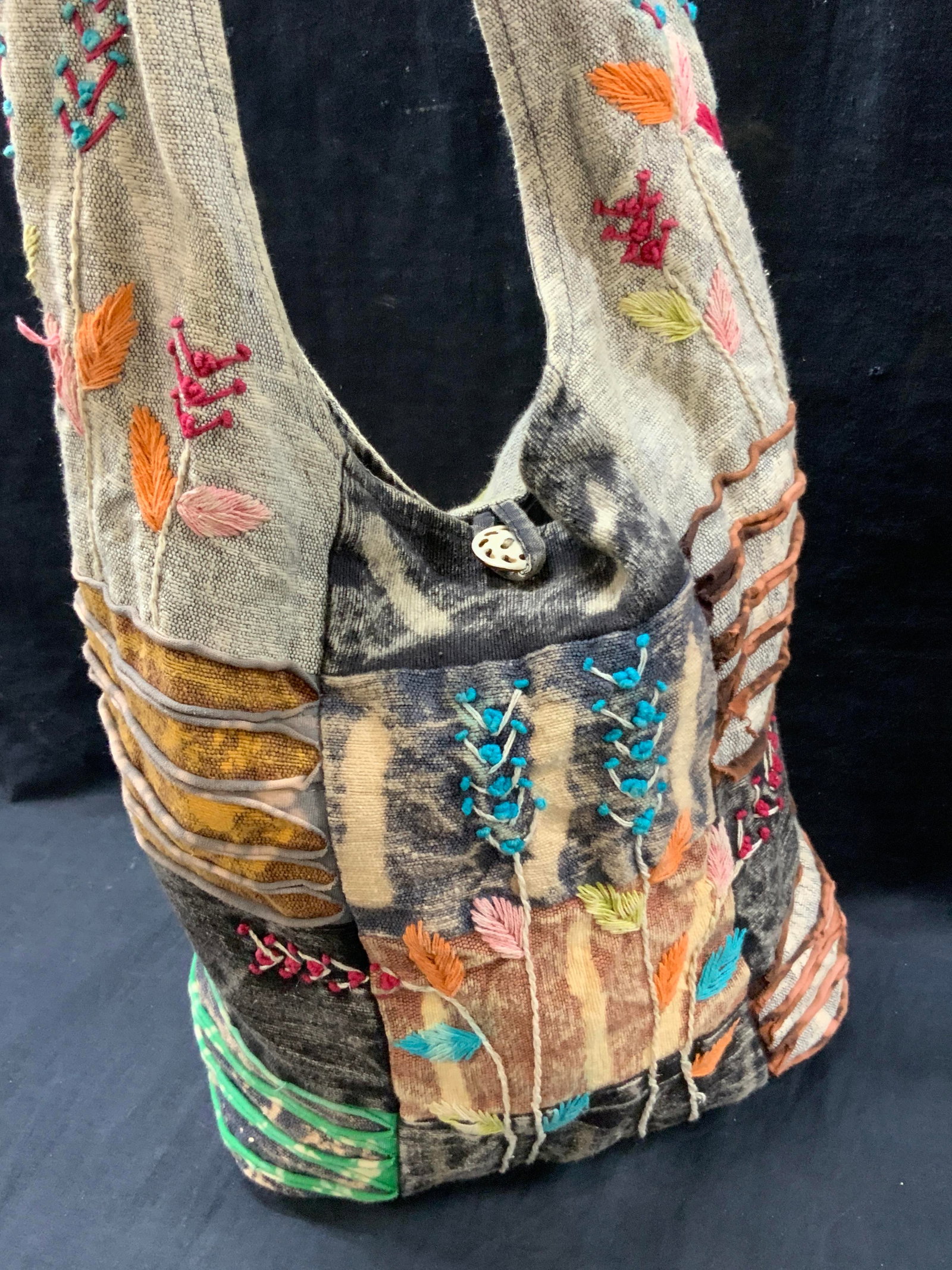 Bohemian Patchwork Tote Bag: Bohemian style patchwork and embroidered tote bag with carved bone buttons with a jade and enamel flower pin on strap. Approx 14 x 13 inches and shoulder strap is 15 inches Moderate wearing to bag due