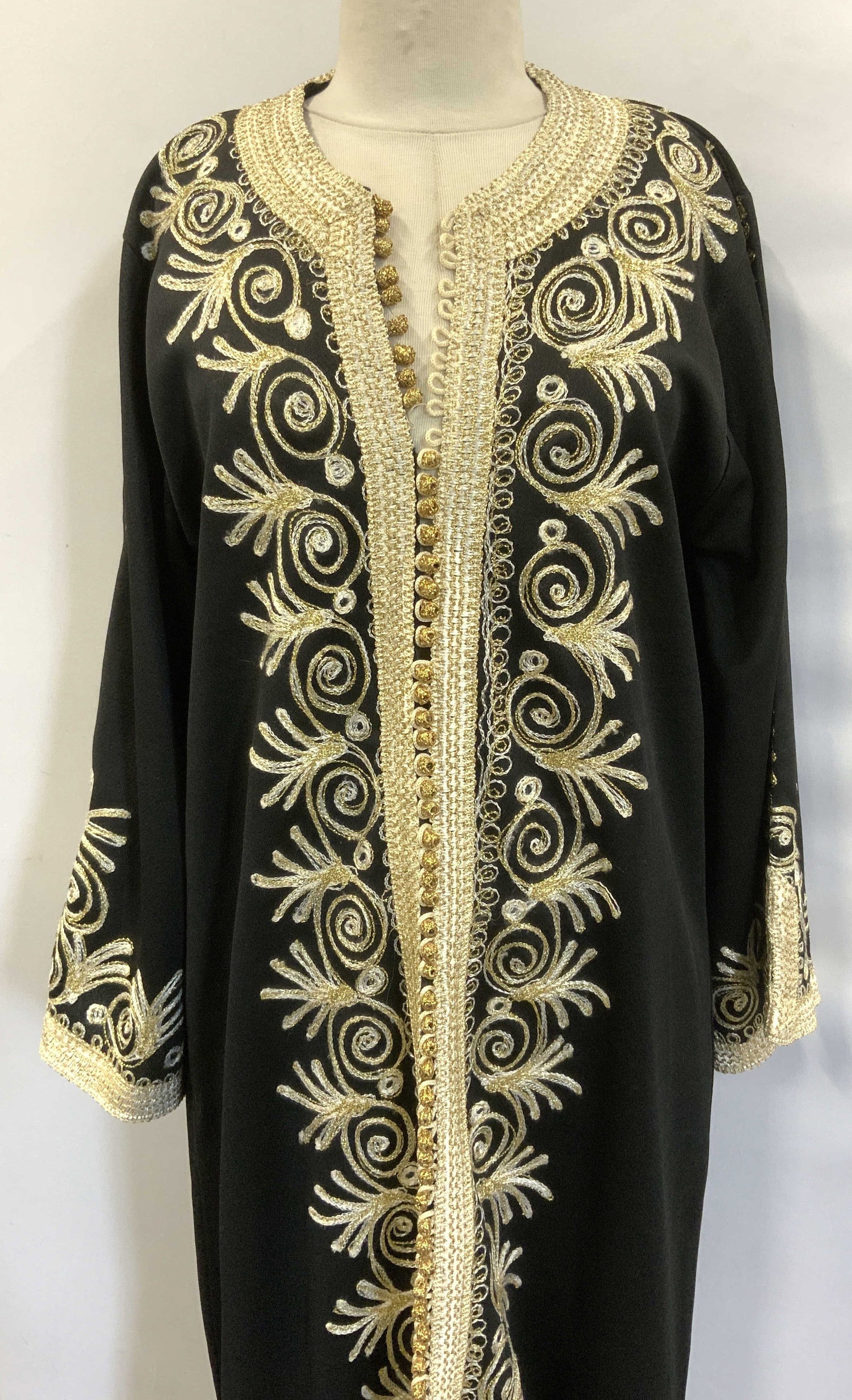 Lilli Rubin Mid Century Embroidered Cocktail Kaftan: Black embroidered mid century cocktail evening Kaftan. Thick and heavy polyester. Possibly c. 1960s. Gold metallic and white embroidery. Gold metallic ball buttons down the center ( 1 missing) . Decor