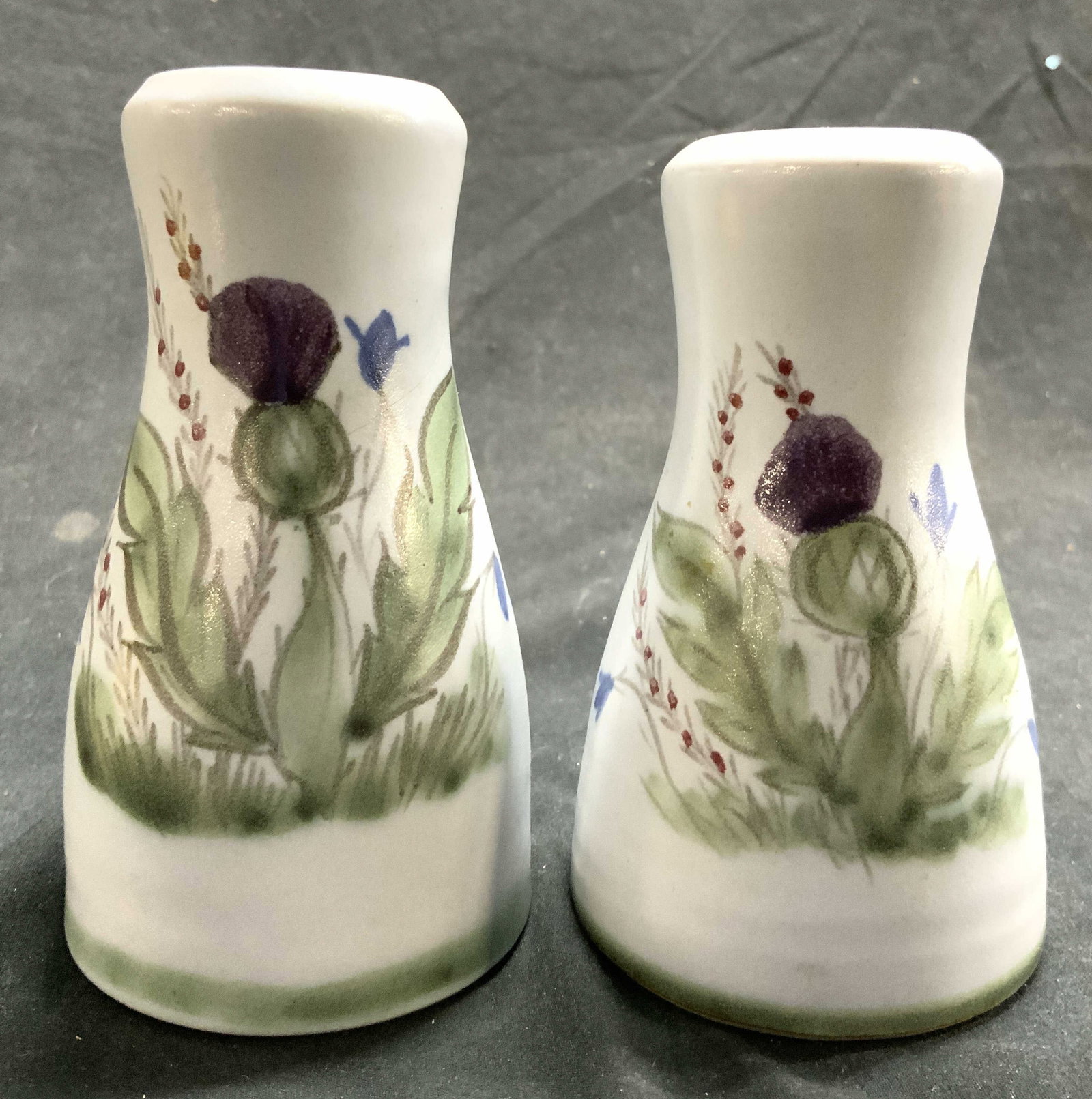 BUCHAN Ceramic Salt & Pepper Shakers Scotland: Undersides are marked BUCHAN MADE IN SCOTLAND. Lot includes 1 salt & 1 pepper shaker. Each appear to be ceramic with multi toned floral & leaf detail. Each piece measures approximately 4.5 inches tall