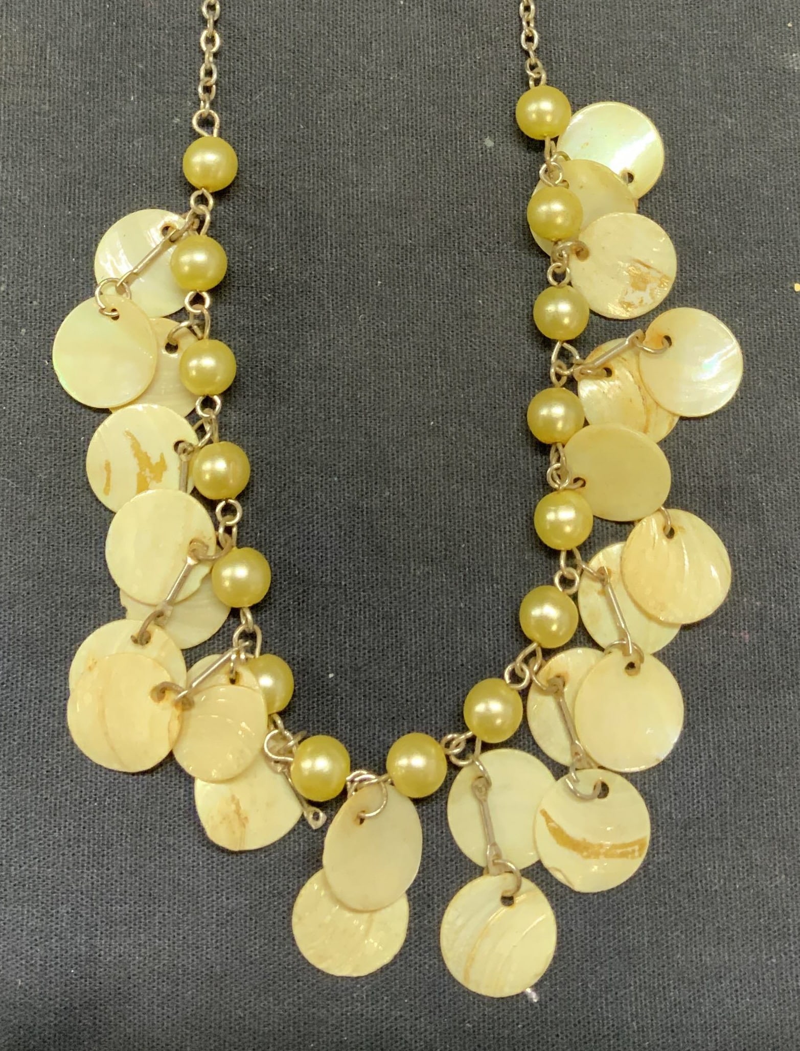 Vintage Faux Pearl MOP Beaded Necklace: Vintage silver tone faux pearl beaded necklace with mother of pearl disc beads. Drop length approx. 9 inches. Some surface wear including scratching observed. Estate jewelry, costume jewelry, fashion 
