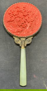 Vintage Cinnabar Style Green Stone Hand Mirror: Vintage carved cinnabar style hand mirror with green stone handle and silver tone frame. Carved floral botanical motif and raised detail on frame. Measures approx. 7.25 x 3.5 inches. Some