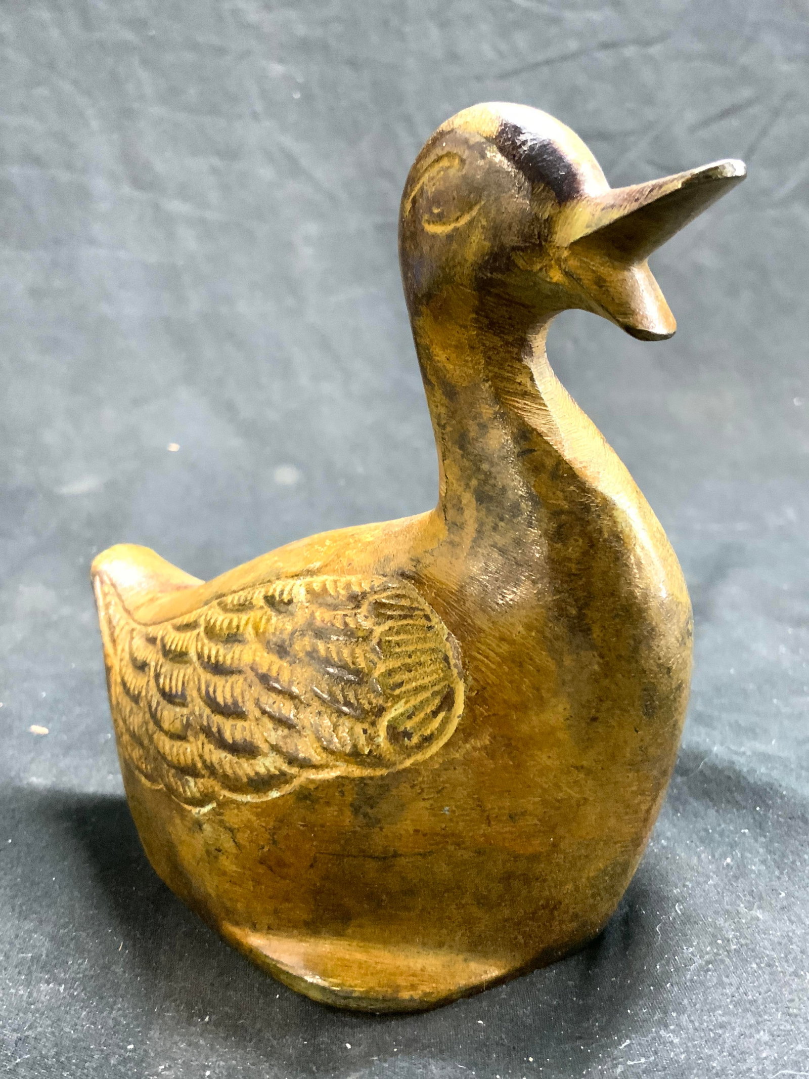 Vintage Iron Duck Figural: Duck figure is vintage. Piece is iron. Duck figure has varying brown and tan tones. Depicts a seated duck with beak open. Piece measures approximately 4.25 inches tall 2.75 inches wide 4.5 inches deep