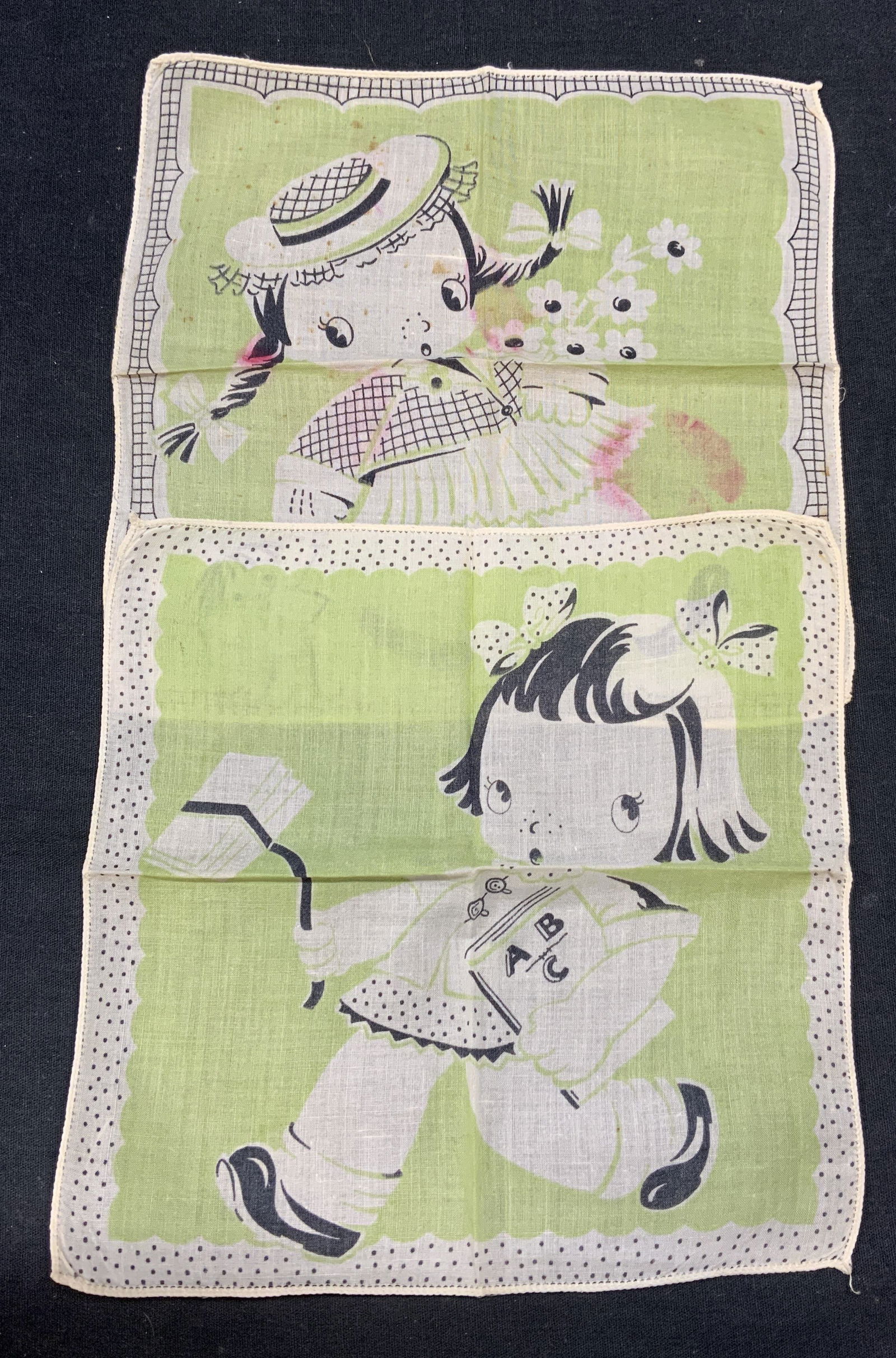 Lot 2 Green Figural Child Handkerchiefs: Lot of 2 vintage green and white handkerchiefs with figural child motif. Material feels like cotton. Measure approx. 8.25 x 8 inches each. Both pieces have some wear to material including blemishes ob