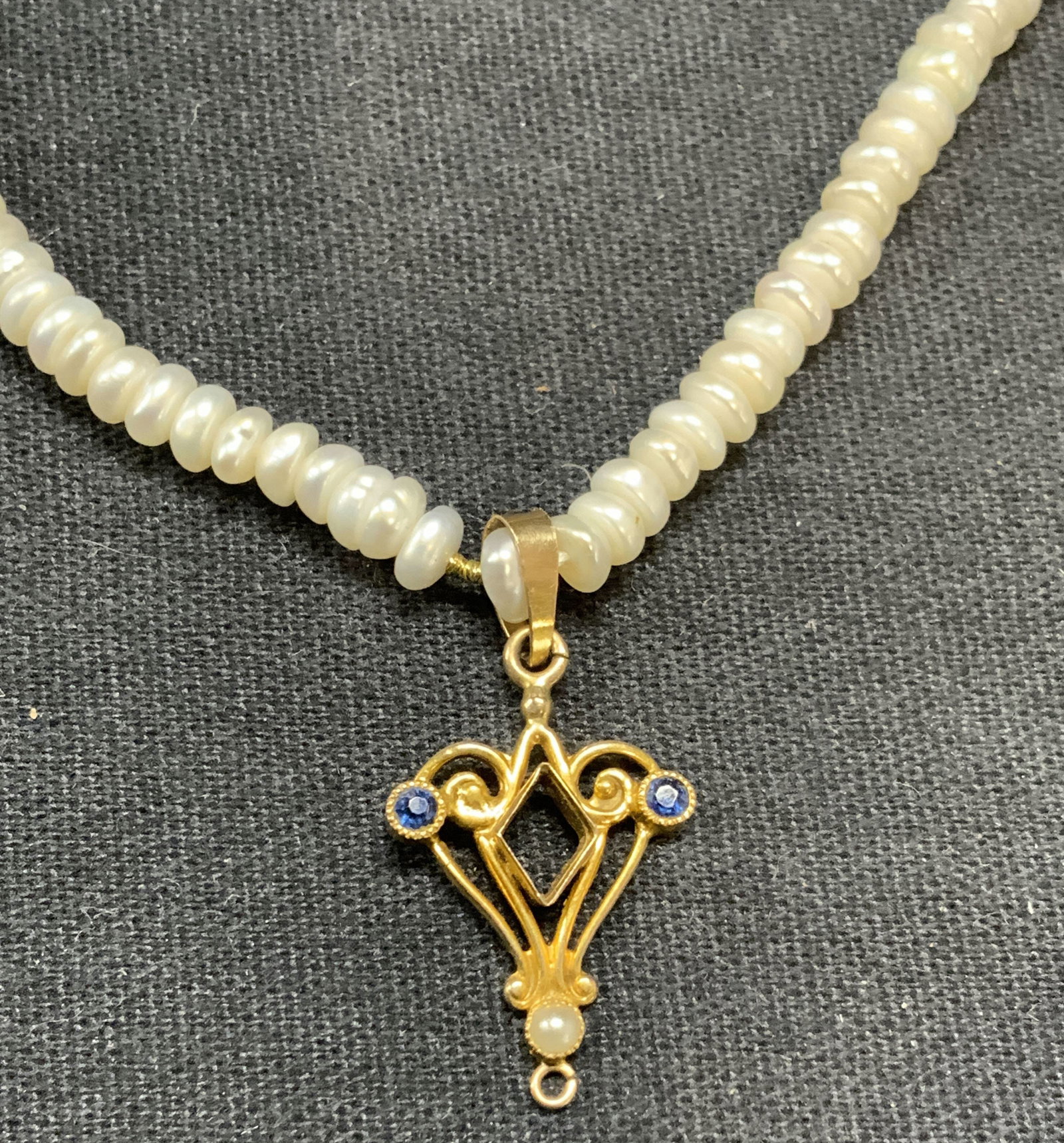 Faux Pearl Beaded Pendant Necklace: Faux pearl beaded necklace with gold tone and crystal decorated pendant. Drop length approx. 8 inches. Some surface wear including scratching observed. Estate jewelry, costume jewelry, cocktail jewelr