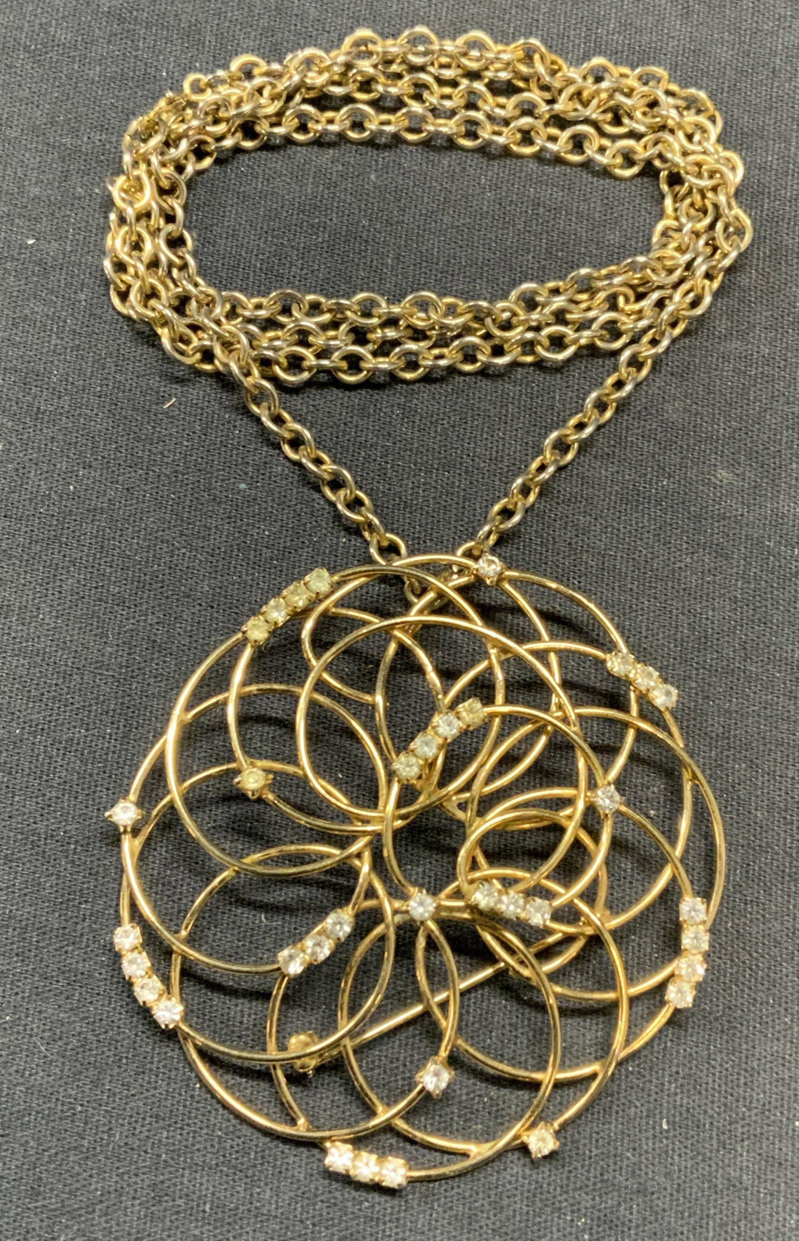 Gold Tone Crystal Pendant Necklace: Gold tone chain necklace with gold tone and crystal decorated pendant brooch. Drop length approx. 13.5 inches. Pendant/brooch measures approx. 2.5 inches wide. Some surface wear including scratching o