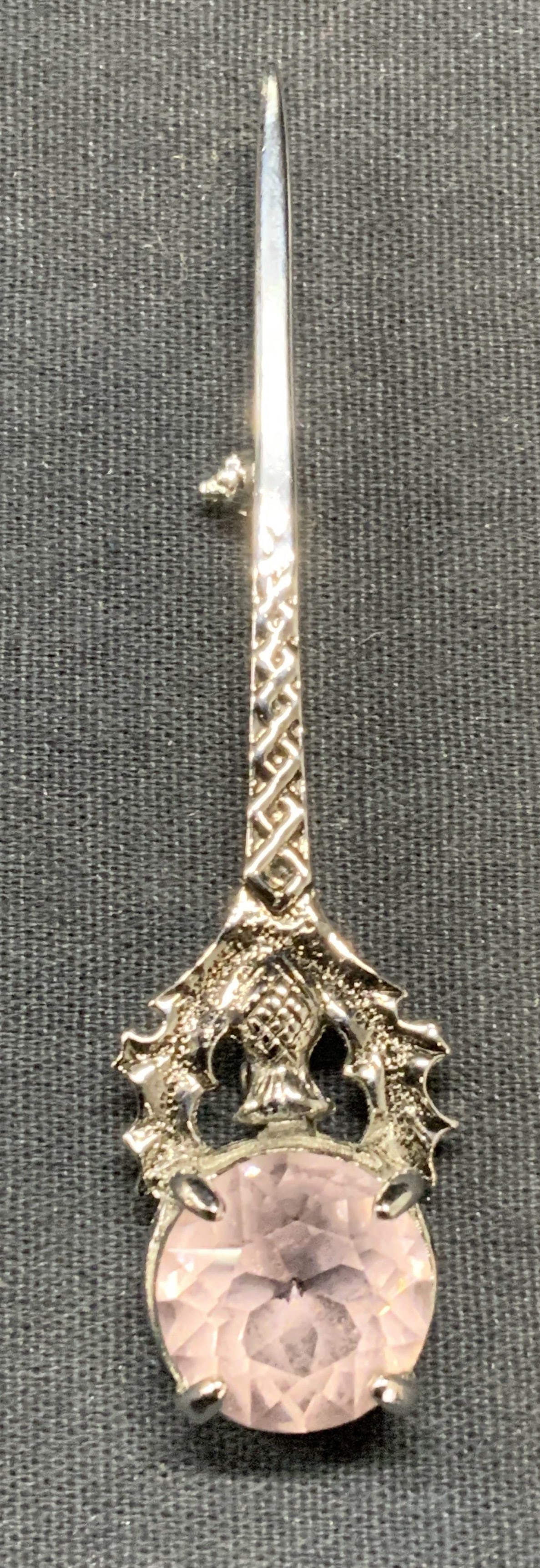 Silver Tone Hallmarked Scotland Crystal Brooch: Silver tone and pink crystal brooch. Raised scroll motif. Marked Scotland and hallmarked illegibly to underside. Measures approx. 3 inches long. Some surface wear including scratching observed. Estate