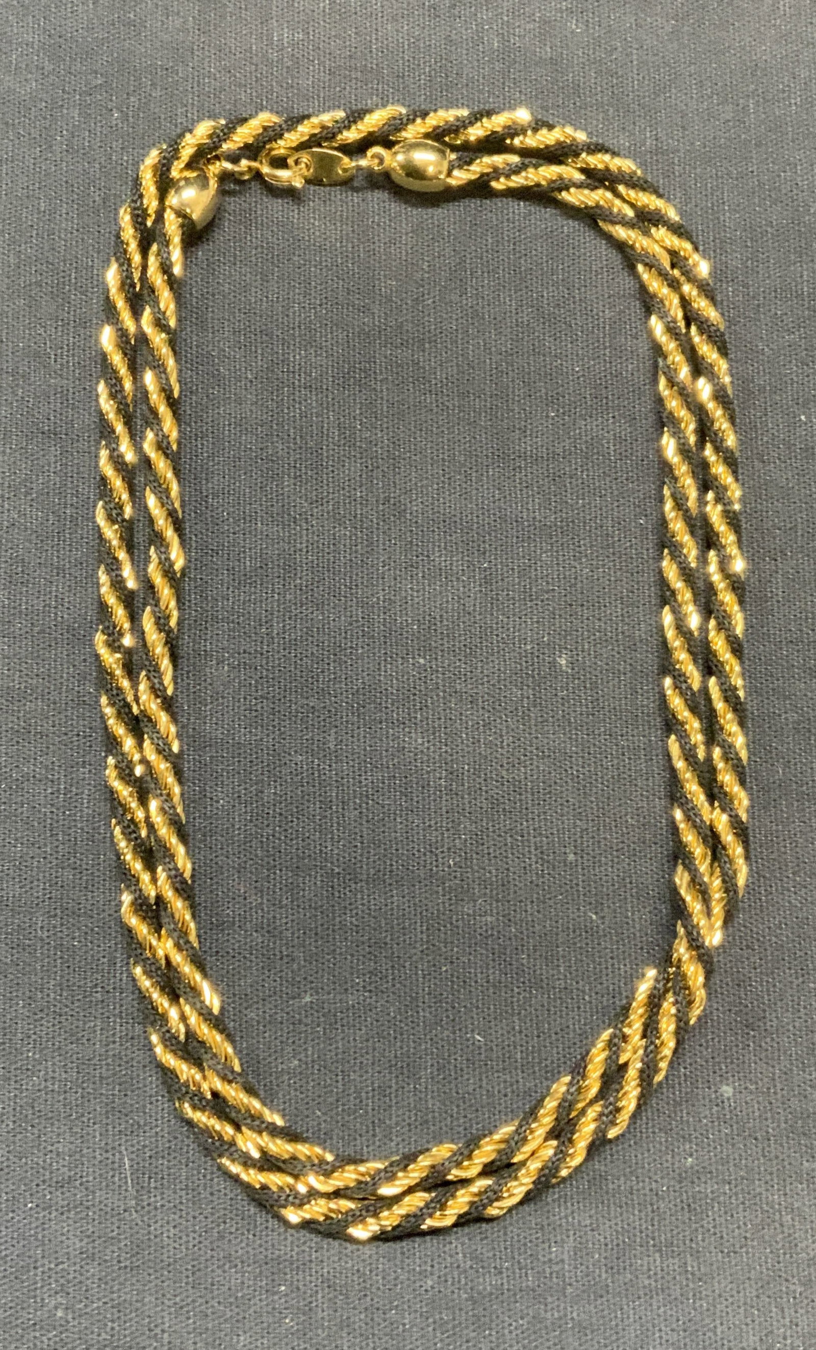 Vintage Trifari Gold Tone Twist Chain Necklace: Vintage Trifari gold tone and black toasted chain necklace. Signed on clasp. Drop length approx. 11.75 inches. Some surface wear including scratching observed. Estate jewelry, costume jewelry, cocktai