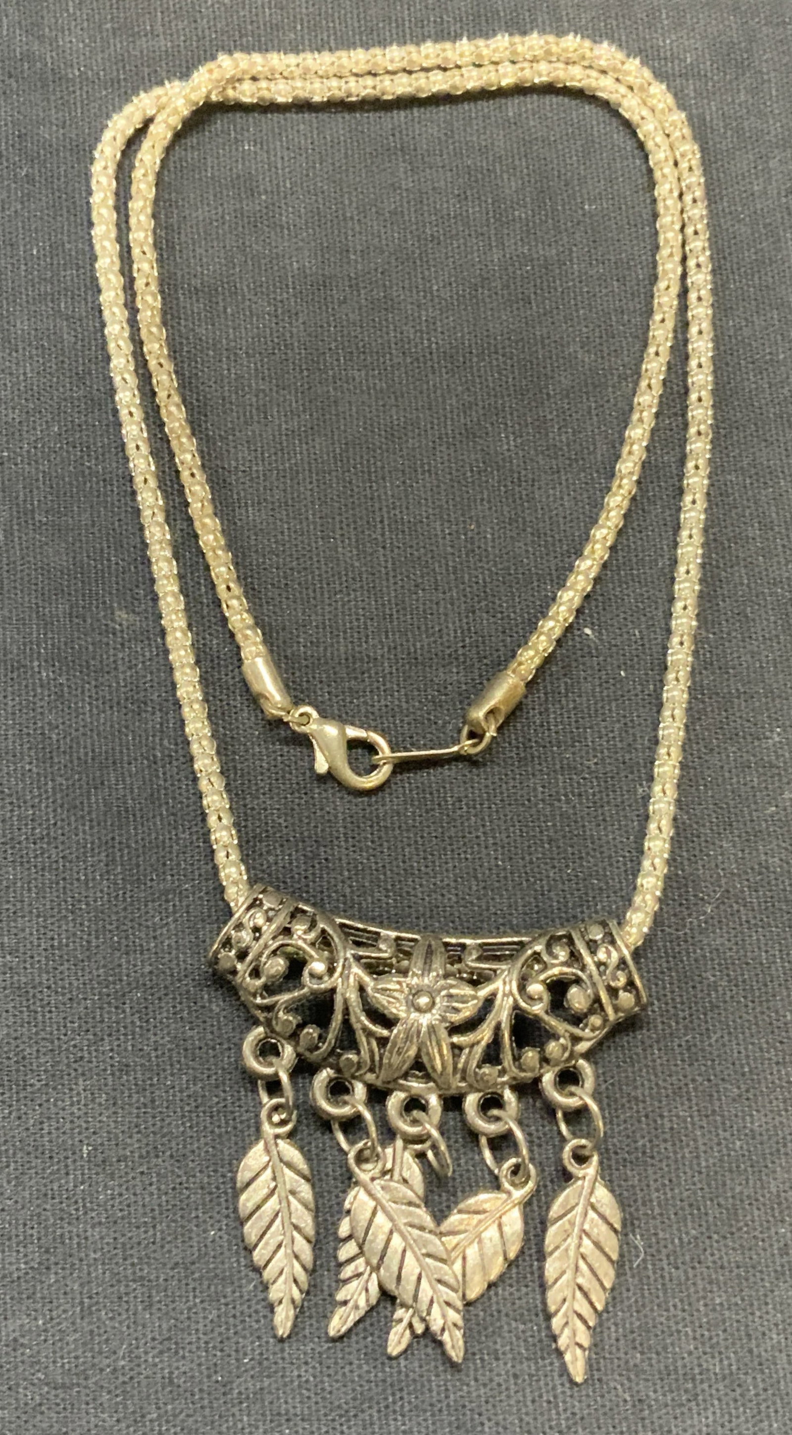 Vintage 18k Gold Filled Pendant Necklace: Vintage 18k gold filled chain pendant necklace with filigree leaf motif pendant. Drop length approx. 8.25 inches. Marked 18k GF on clasp. Some surface wear including scratching observed. Estate jewelr