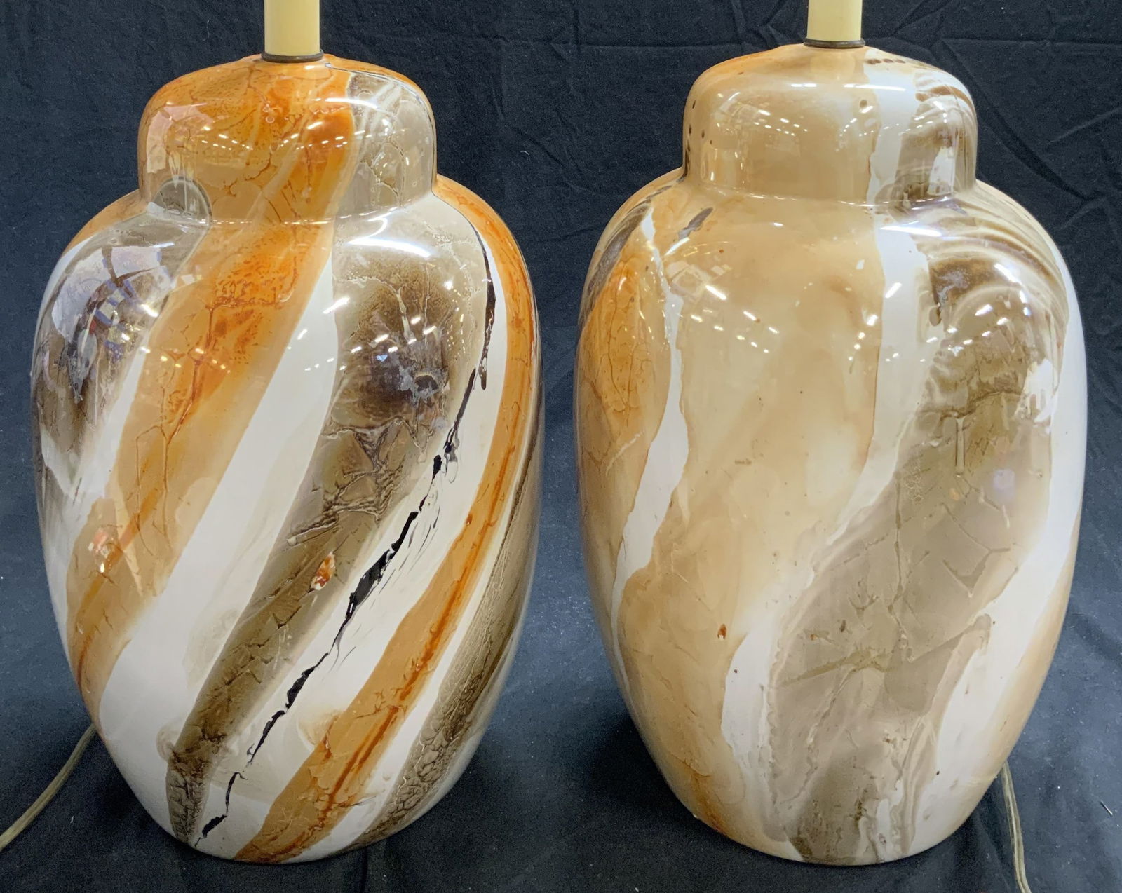 Near Pr Mid Century High Gloss Glass Table Lamps: Lamps are mid century. Each piece is glass with high gloss finish. Each lamp includes harp & finial. Lamps are a near pair. Each lamp measures approximately 28 inches tall 9 inches wide. Lamps, table