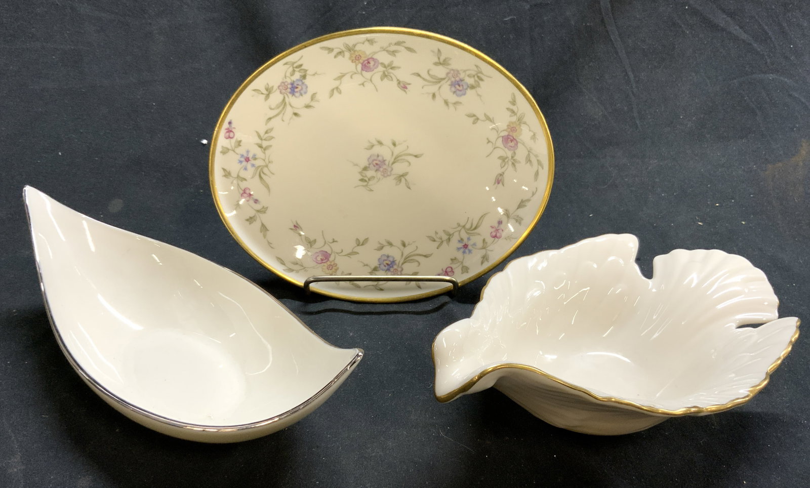 Lot 3 Vintage Porcelainware Lenox USA & More: Lot includes 1 dove form porcelain bowl with gilt rim, marked LENOX MADE IN USA on underside, 1 boat shaped vessel with silver toned rim also marked LENOX on underside & 1 floral detailed oval gilt ri