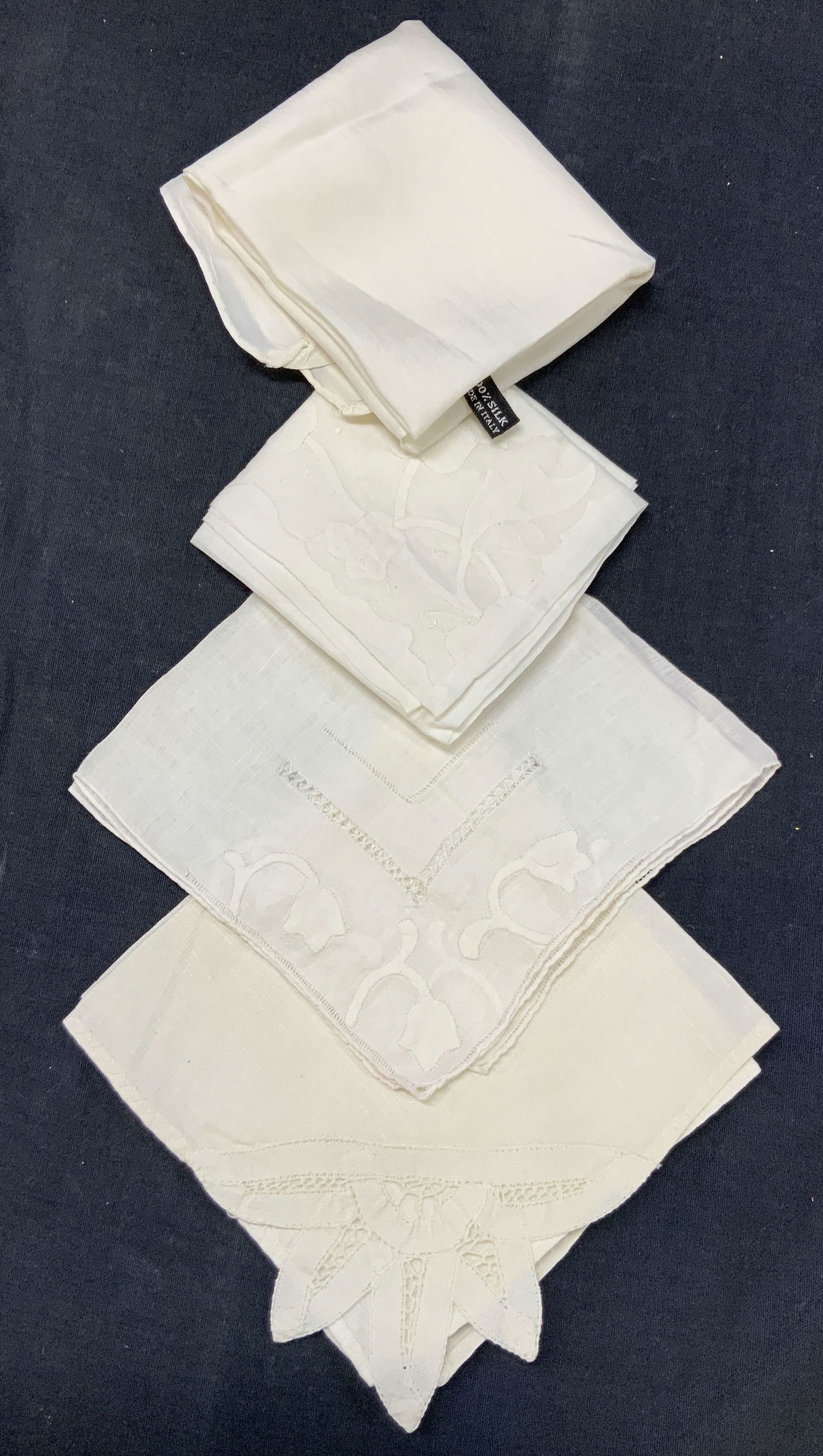 Lot 4 Silk & Linen Handkerchiefs: Lot of 4 vintage off white linen and silk made embroidered handkerchiefs. 1 marked on tag, 100% silk made in Italy, approx, another cotton piece with floral appliques. 1 linen with lace accents on cor