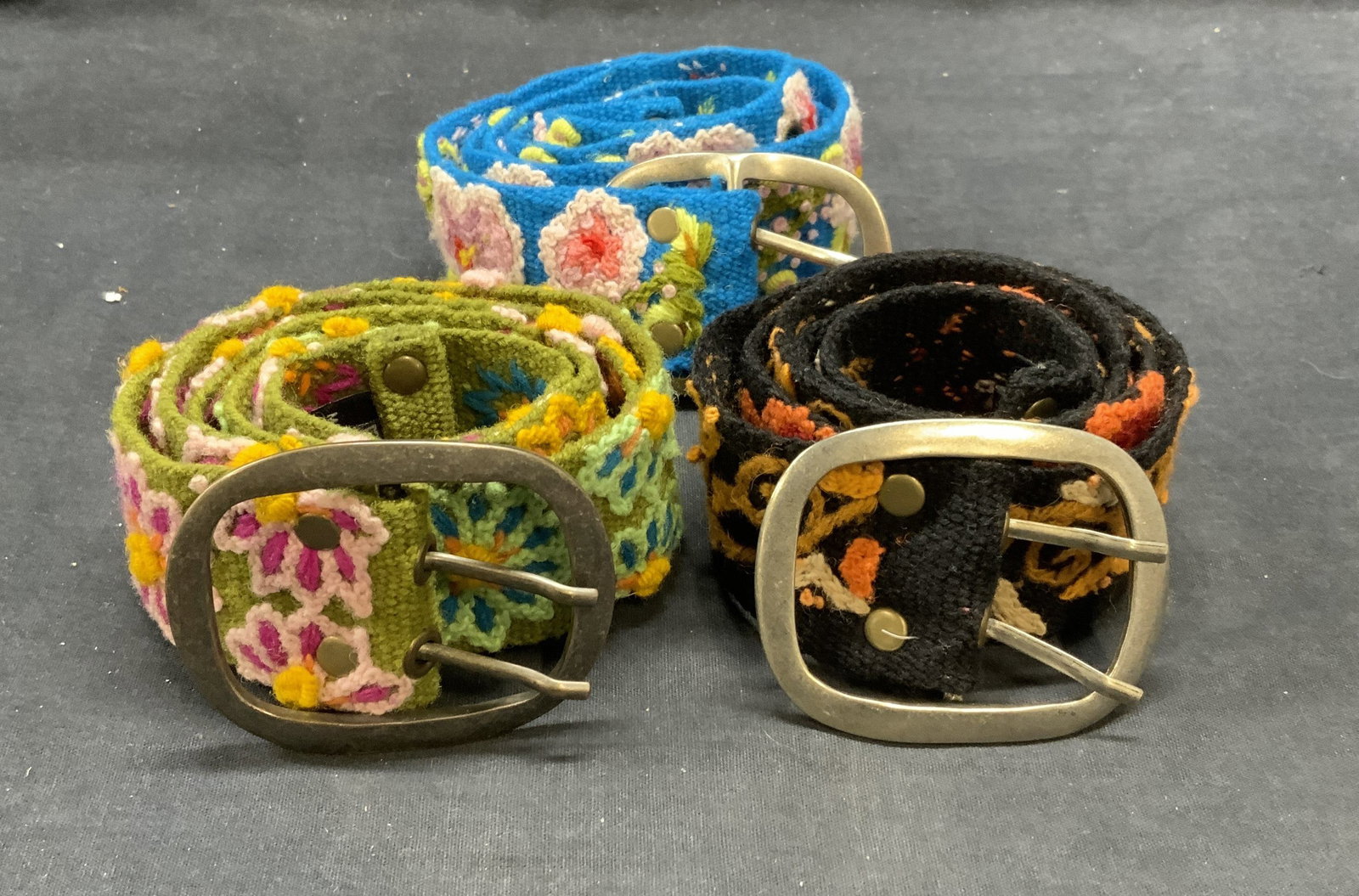 Lot 3 Jenny Krauss Floral Belts: Lot of 3 Jenny Krauss floral pattern belts in green, blue, and black. All size medium. 100% wool. All pieces have some wear to material consistent with exposure. Jenny Krauss, Jenny Krauss belt, ladie