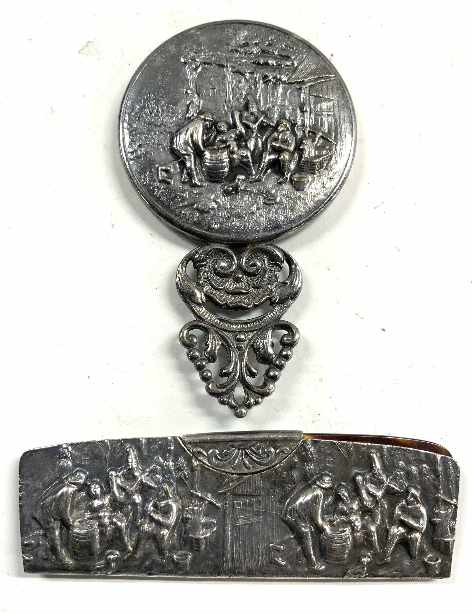 SILVER PLATE Lot 2 Vntg Comb & Mirror DENMARK: Each piece in lot is inscribed MADE IN DENMARK. Pieces in lot are Silver Plated. Lot includes 1 comb & 1 handheld mirror. Each piece has intricate beveled detail of multiple figures. Mirrored surface 