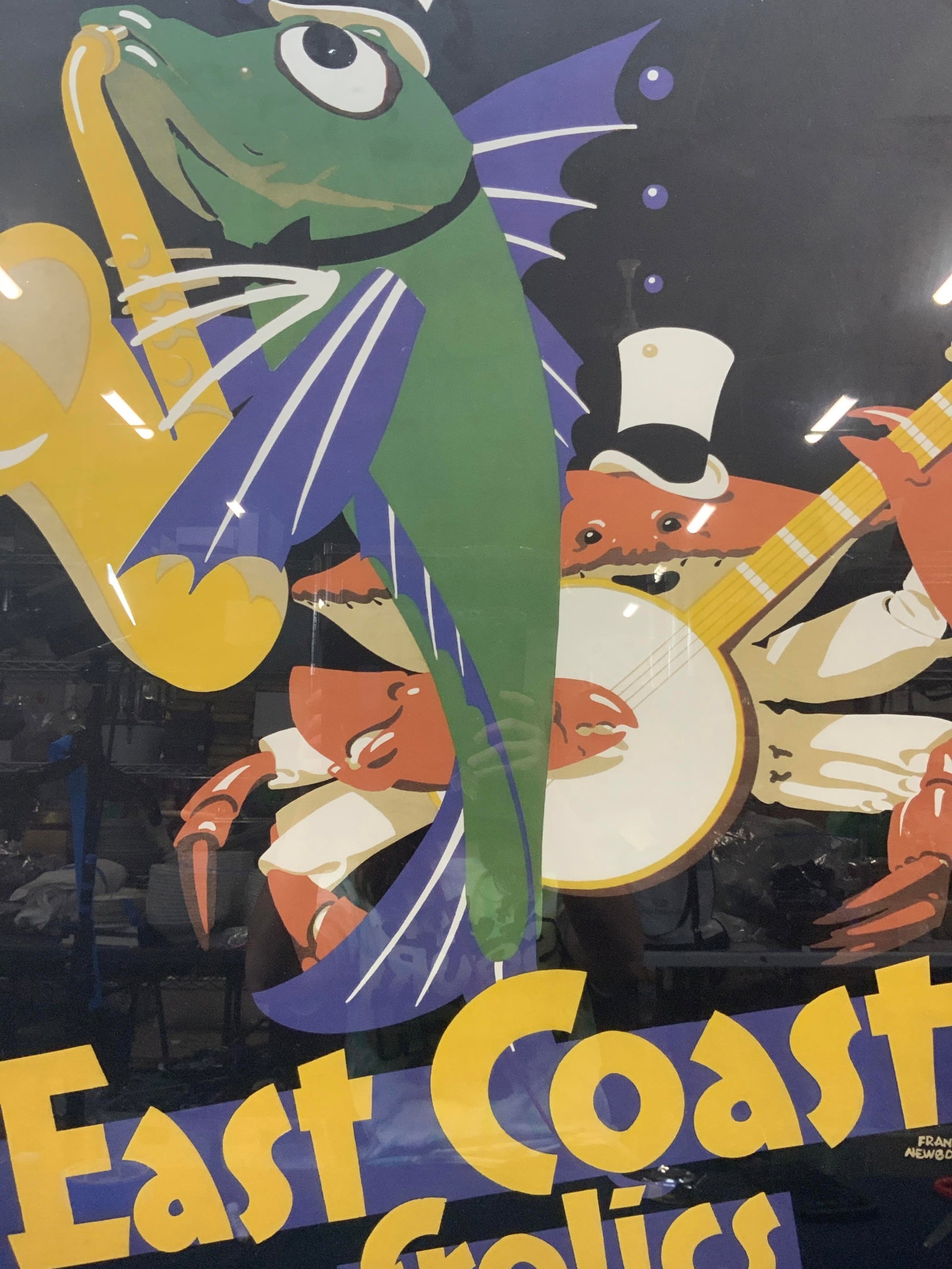 Frank Newbould East Coast Frolics Advert: Marked The east coast frolics. No. 6 Those drier side blues, travel cheaply by I.N.E.R. Depicts a fish and a crab playing instruments Framed in a black metal frame. Approx 3ft x 2ft window measures, 3