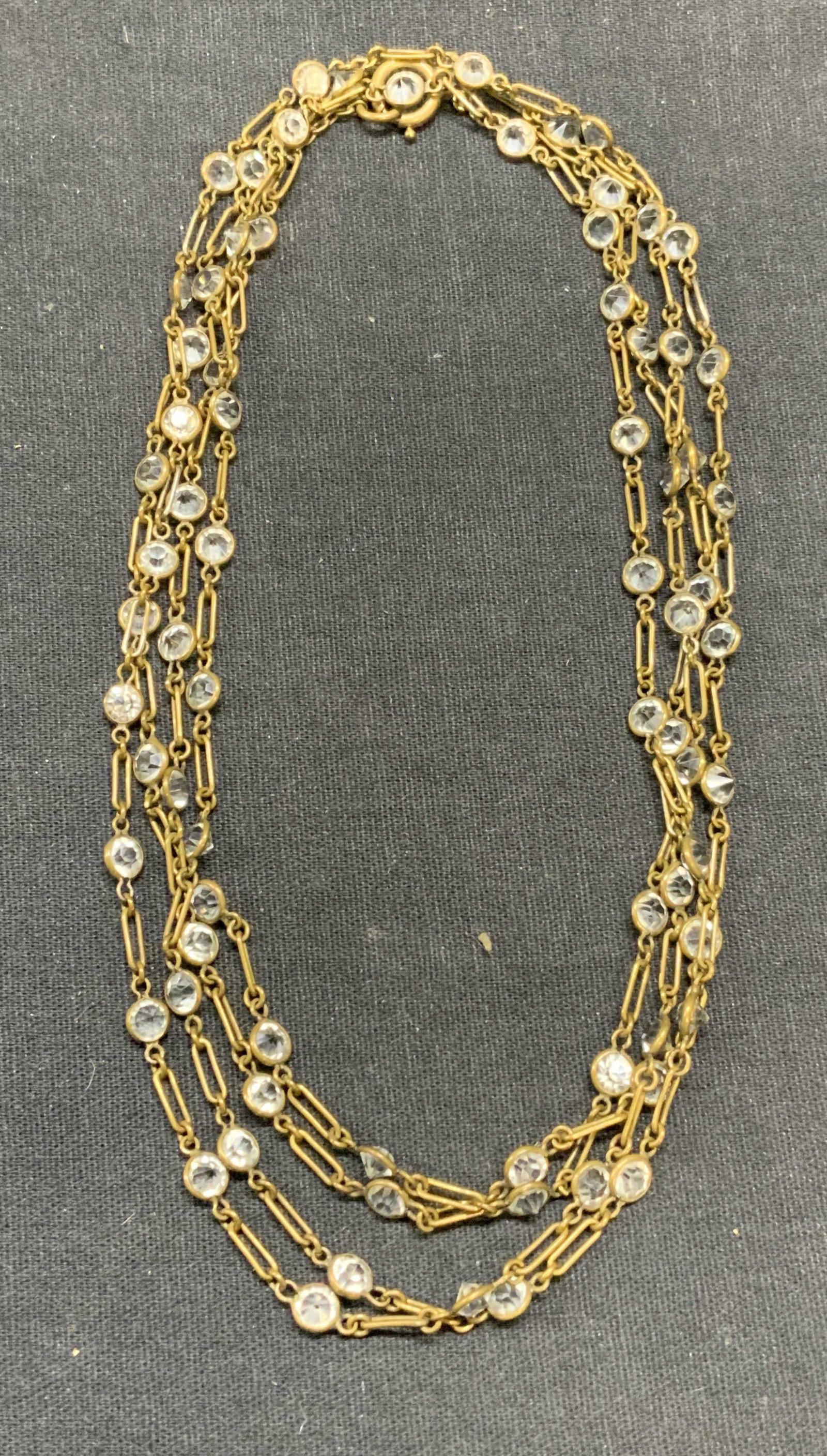 Vintage Gold Tone Crystal Necklace: Vintage gold tone colorless crystal decorated necklace. Drop length approx. 28.5 inches. Some surface wear including scratching observed. Estate jewelry, costume jewelry, cocktail jewelry, fashion jew