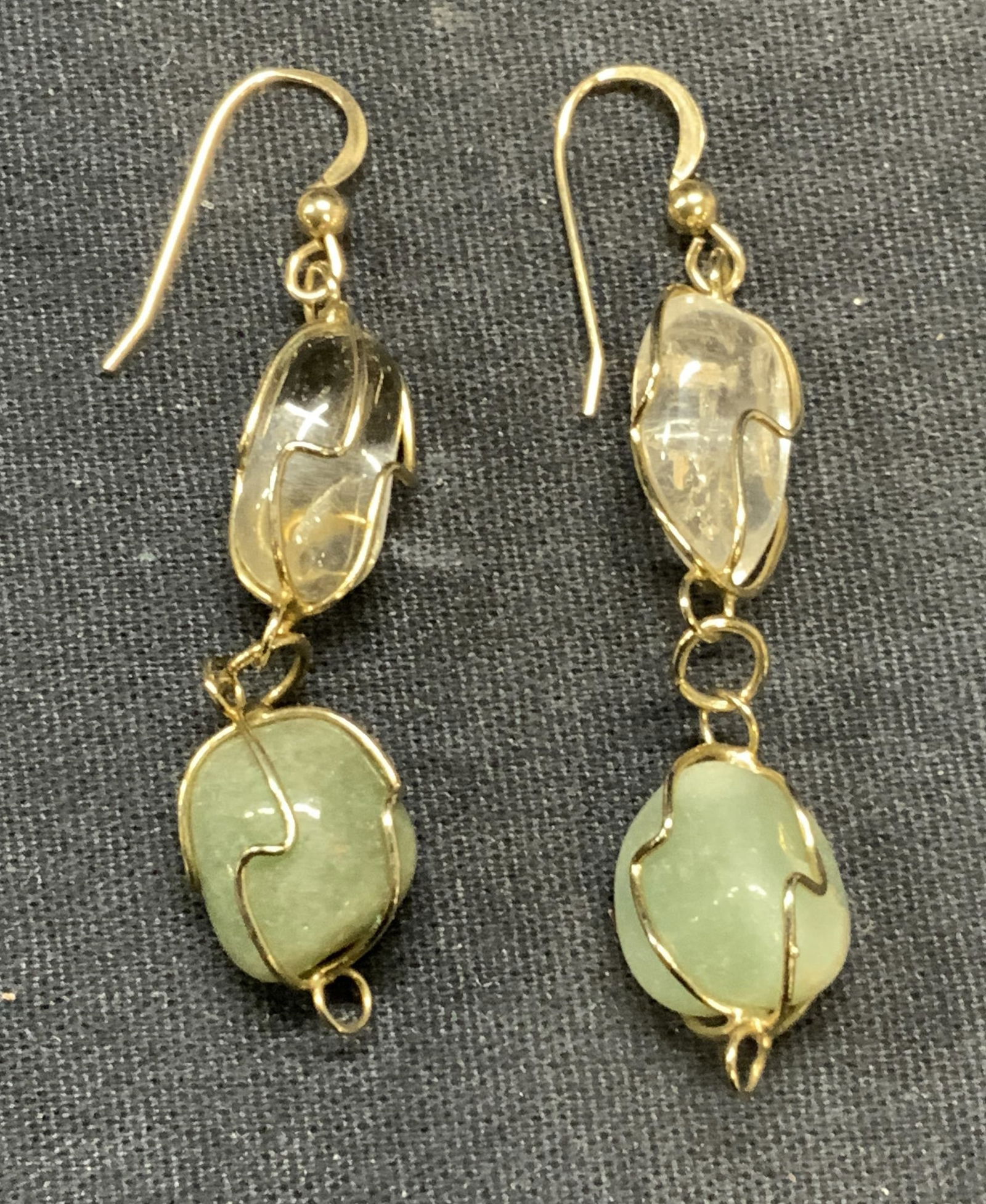 Gold Tone Jadeite & Quartz Earrings: Jadeite and Quartz dangle earrings. Possibly gold filled wire. Measure approx. 1.5 inches long. Total weight 8.4 grams. Includes jewelry pouch. Some surface wear including scratching observed. Estate