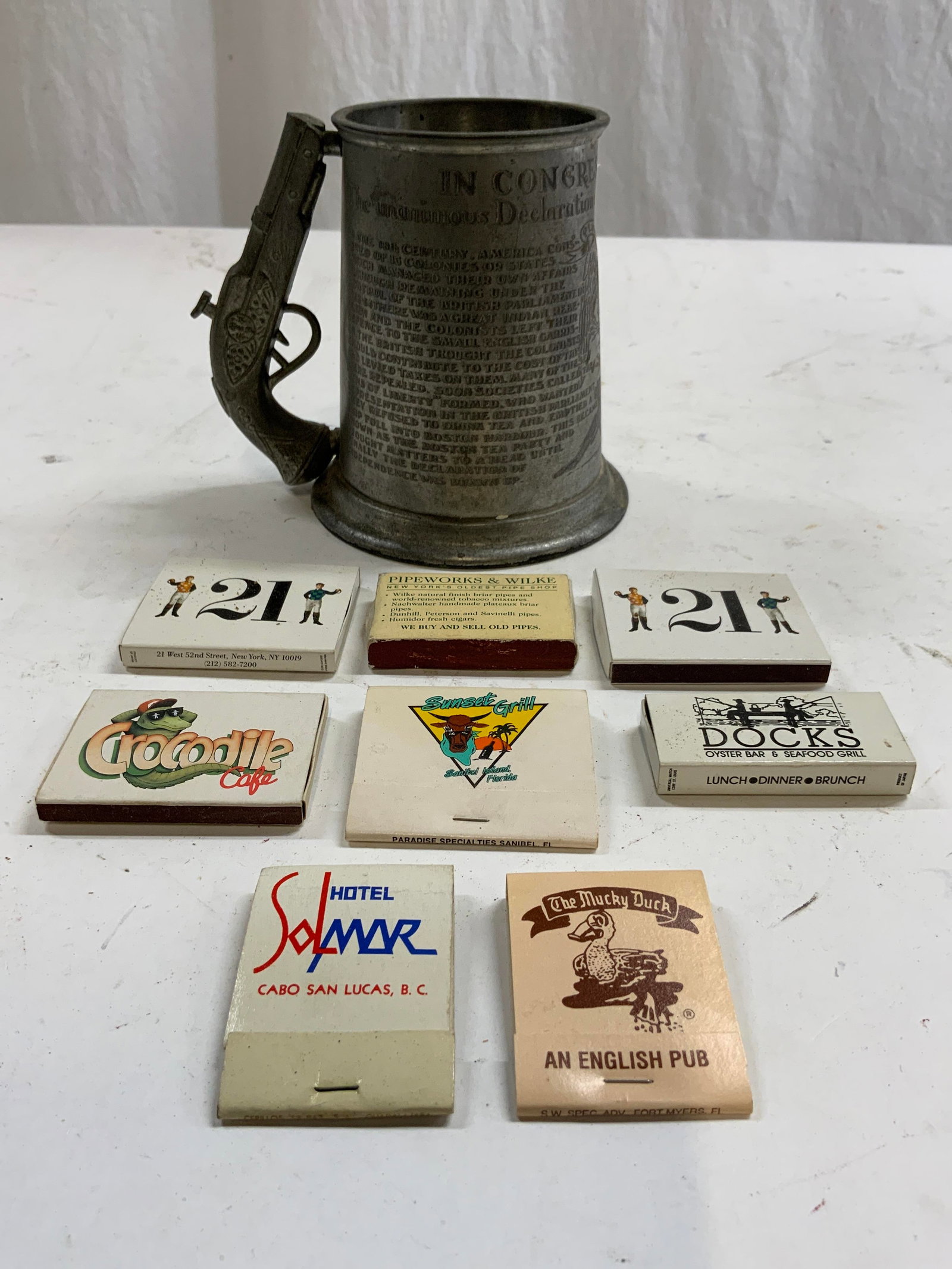 LEONARD SHEFFIELD Eng Pewter Tankard & Matchbooks: Underside reads LEONARD EALES OF SHEFFIELD ENGLISH PEWTER TANKARD. Piece is silver toned and pewter. Tankard has pistol form handle and United States seal, in relief. Piece has writing in relief. Lot 