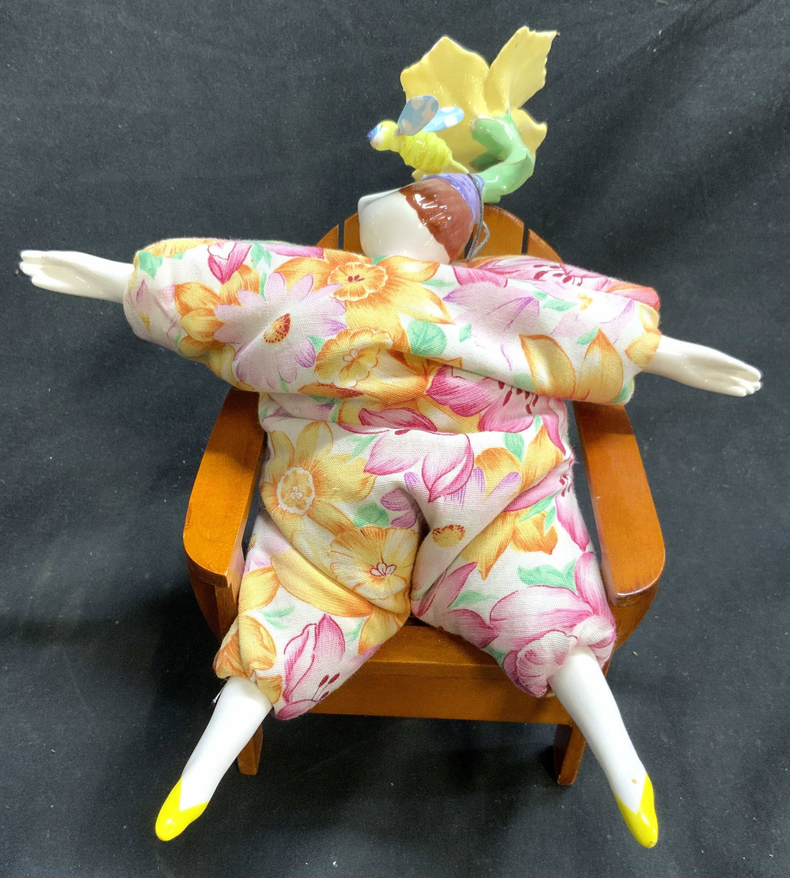 Poupee Millet Doll & Chair Wooden Chair: Poupee Millet doll has porcelain head, arms & legs. Bean bag body with multi toned floral detail. Doll has porcelain flower at top of head. Chair is light brown toned, appears to be wooden. And insect