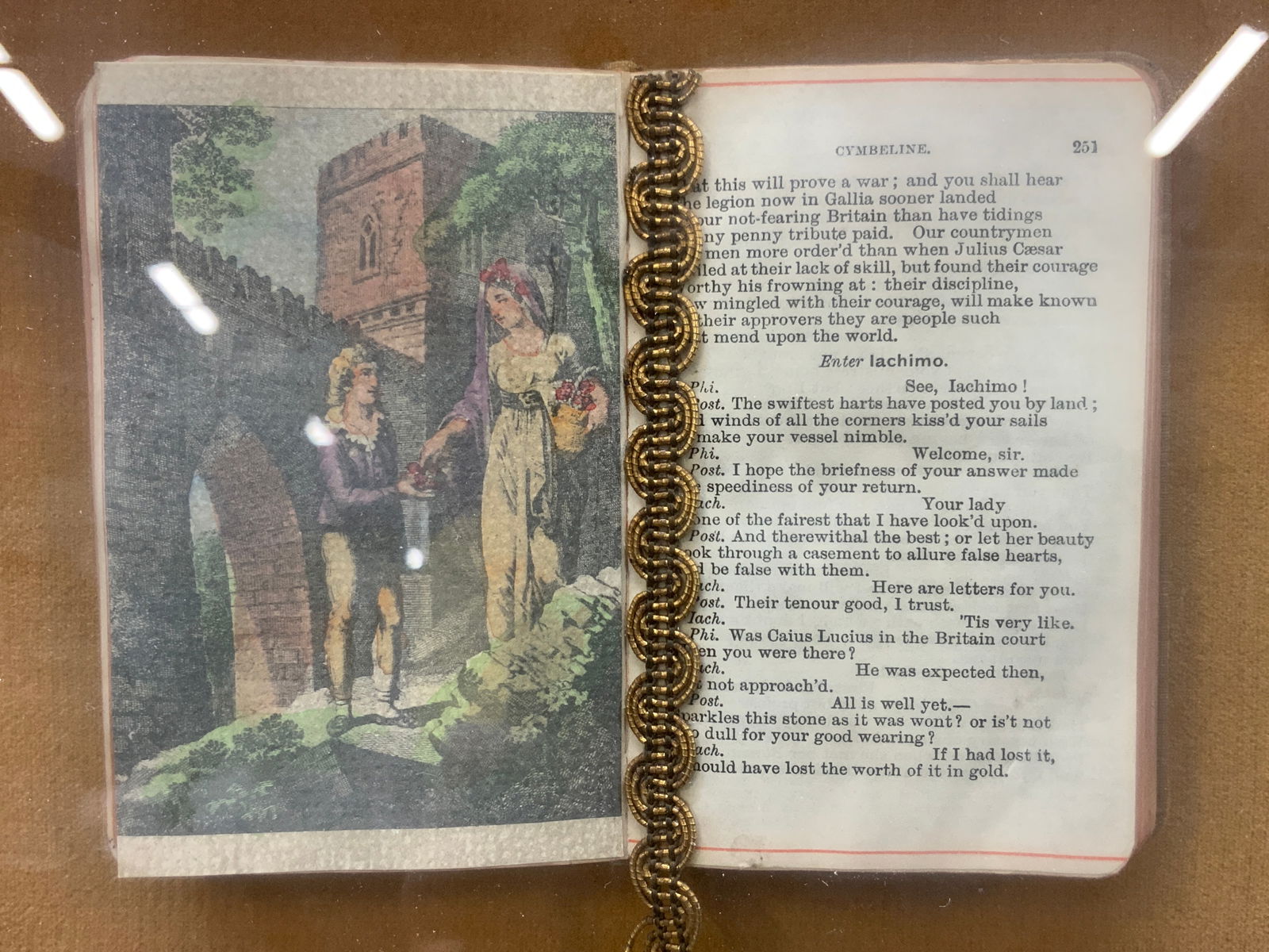 Hand Painted Cymbeline Shakespeare Mounted Booklet: Vintage, possibly antique Shakespeare Cymbeline booklet with hand painted engraving page of a man and woman. Booklet is mounted in a gold leafed wooden frame with gold toned fabric backing. Approx 12