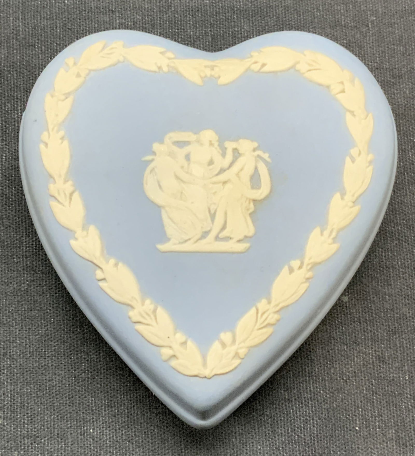 Wedgwood Blue Jasperware Heart Trinket Box: We wood blue Jasperware heart shaped trinket box. Raised white bas relief with Greco Roman and floral motif. Signed to underside. Made in England. Measures approx. 3 x 2.75 x 1.5 inches. Some surface