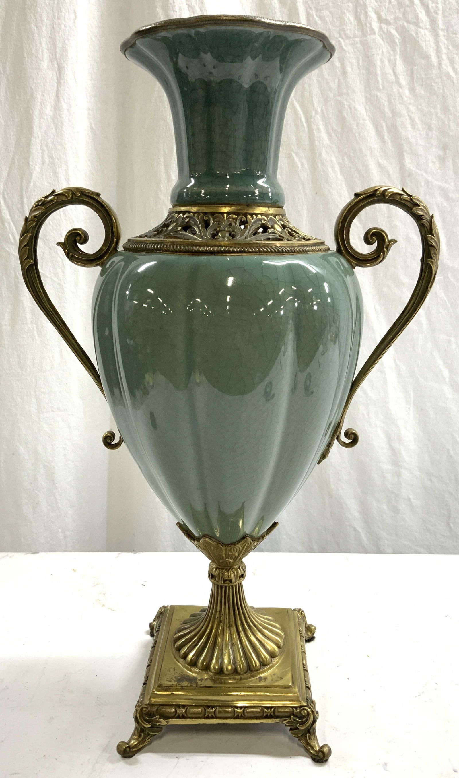 Vntg Celadon Porcelain & Gilt Metal Urn Vessel: Urn is porcelain with gilt metal base, & handles. Base has curled scrolled feet. Piece has curled scroll handles & metal rim. Lower neck has pierced gilt metal area. Vessel measures approximately 19 i