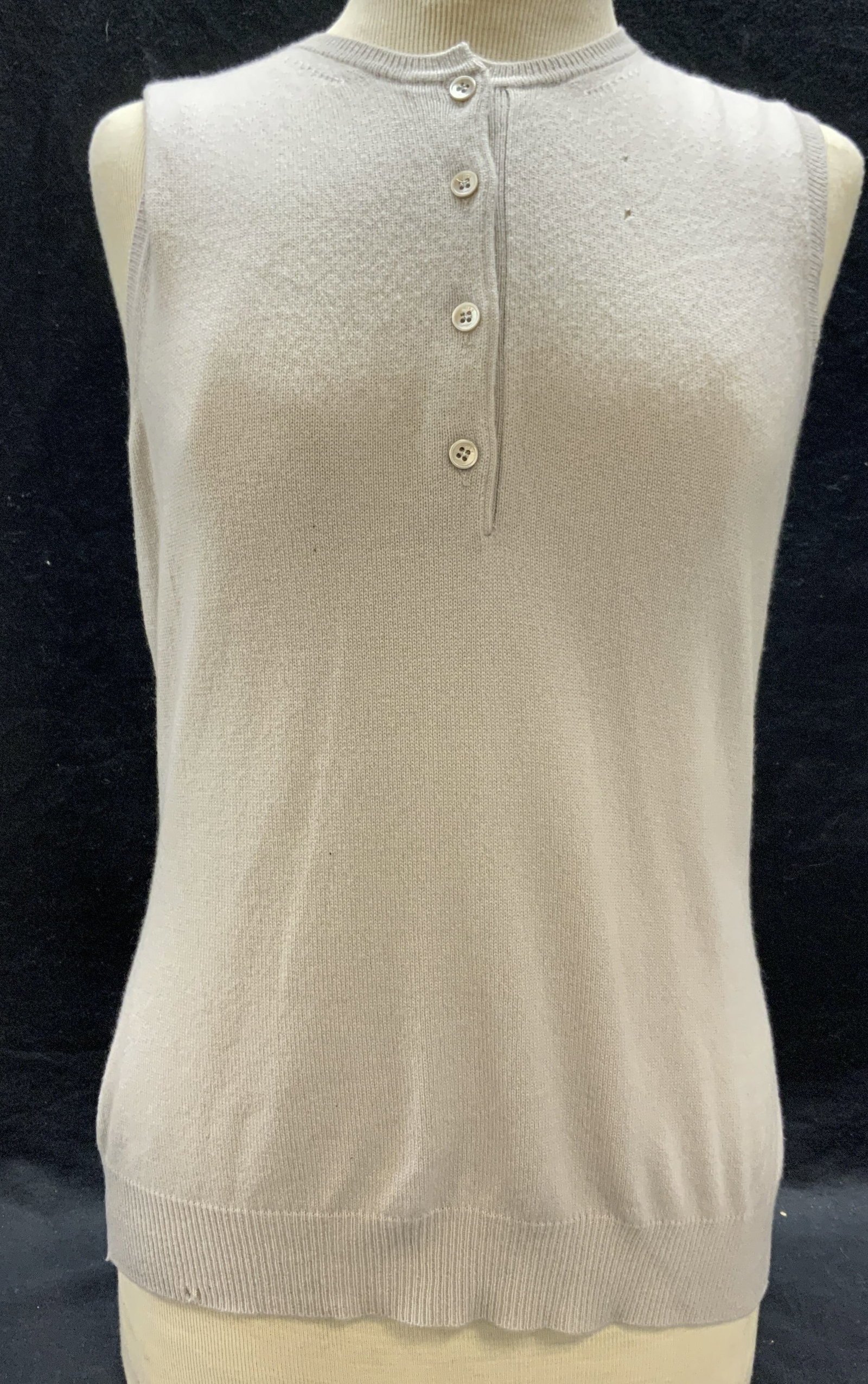 Asprey London Sleeveless Cashmere Sweater Italy: Asprey London lavender sleeveless sweater with front button detail. Size M. 100% cashmere. Made in Italy. Some wear to material consistent with exposure. Some holes observed. Asprey London, Asprey Lon
