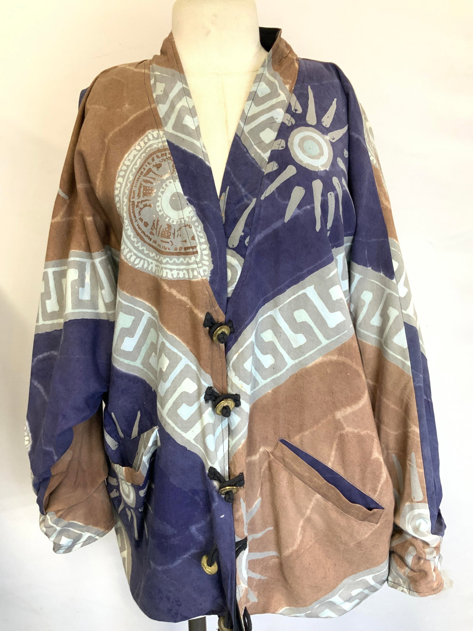 Patterned Cotton Over Jacket: Patterned, over jacket with Asian coins as button, adorn with Madala patterns with suns in tones of brown and purple. No tag Sleeves measures 14 inches long. Torso measures 28 inches down and chest me