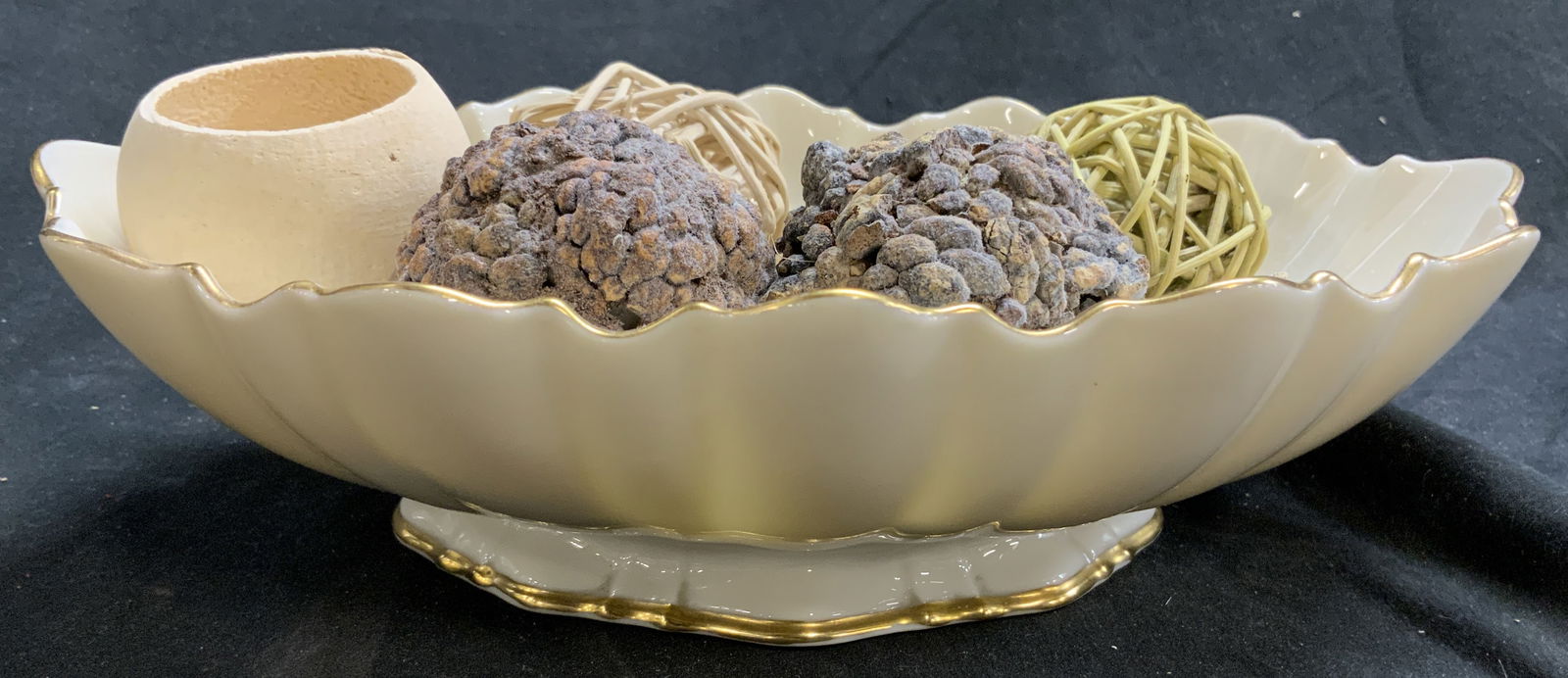 Lenox Lot 7 Porc Gilt Rim Vessel W Assorted Decor: Lot includes cream toned vessel with gilt rim with assorted decorative objects sitting inside. Vessel is footed. Piece has leaf relief detail. Includes 6 decorative objects. Vessel measures approximat