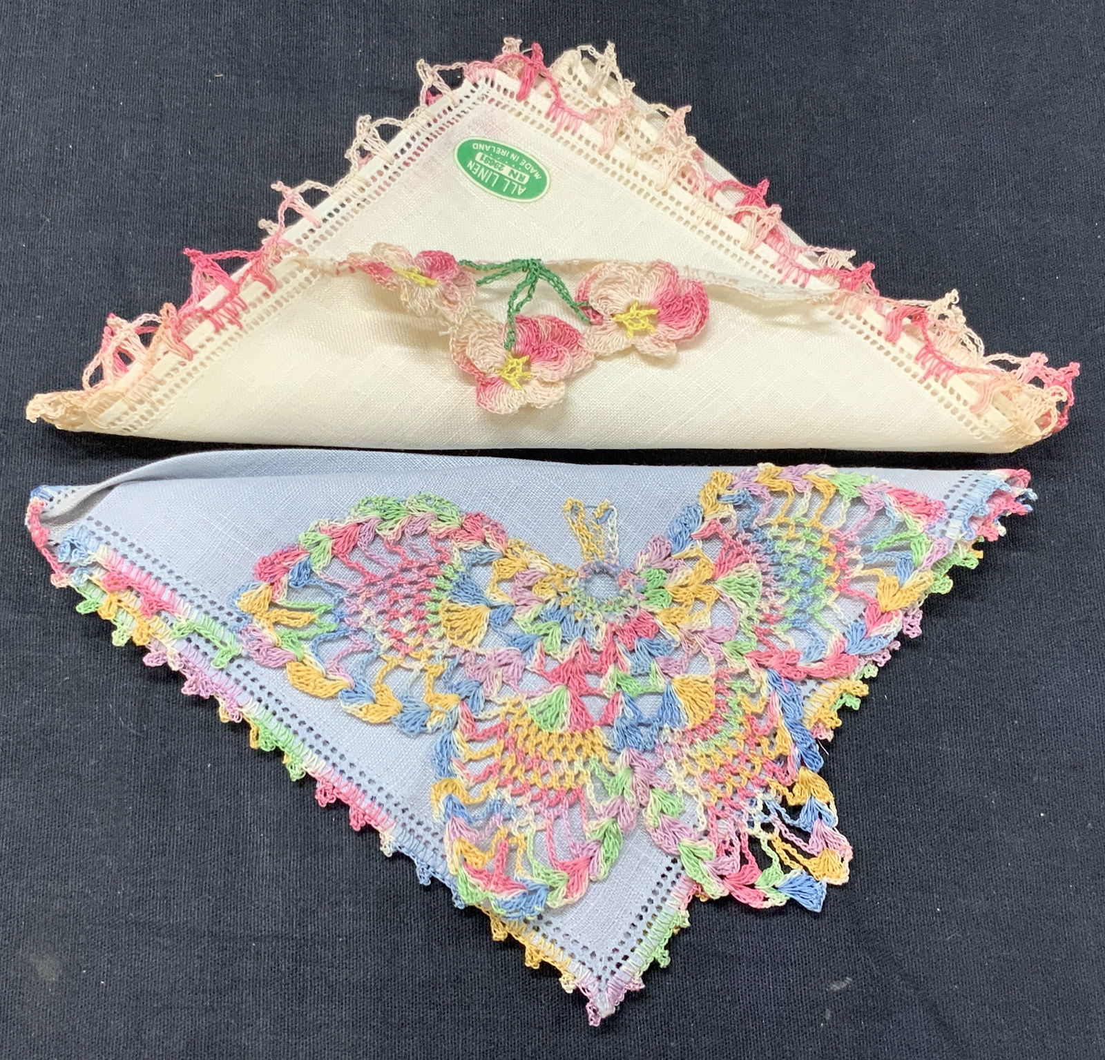 2 Crocheted Floral & Butterfly Linens, Ireland: Lot of 2 linen Handkerchiefs, 1 with multicolored edges and corners with a crocheted butterfly on corner and another with red and pink edges with flower corners. Marked all linen, Approx 11 x 11 inche